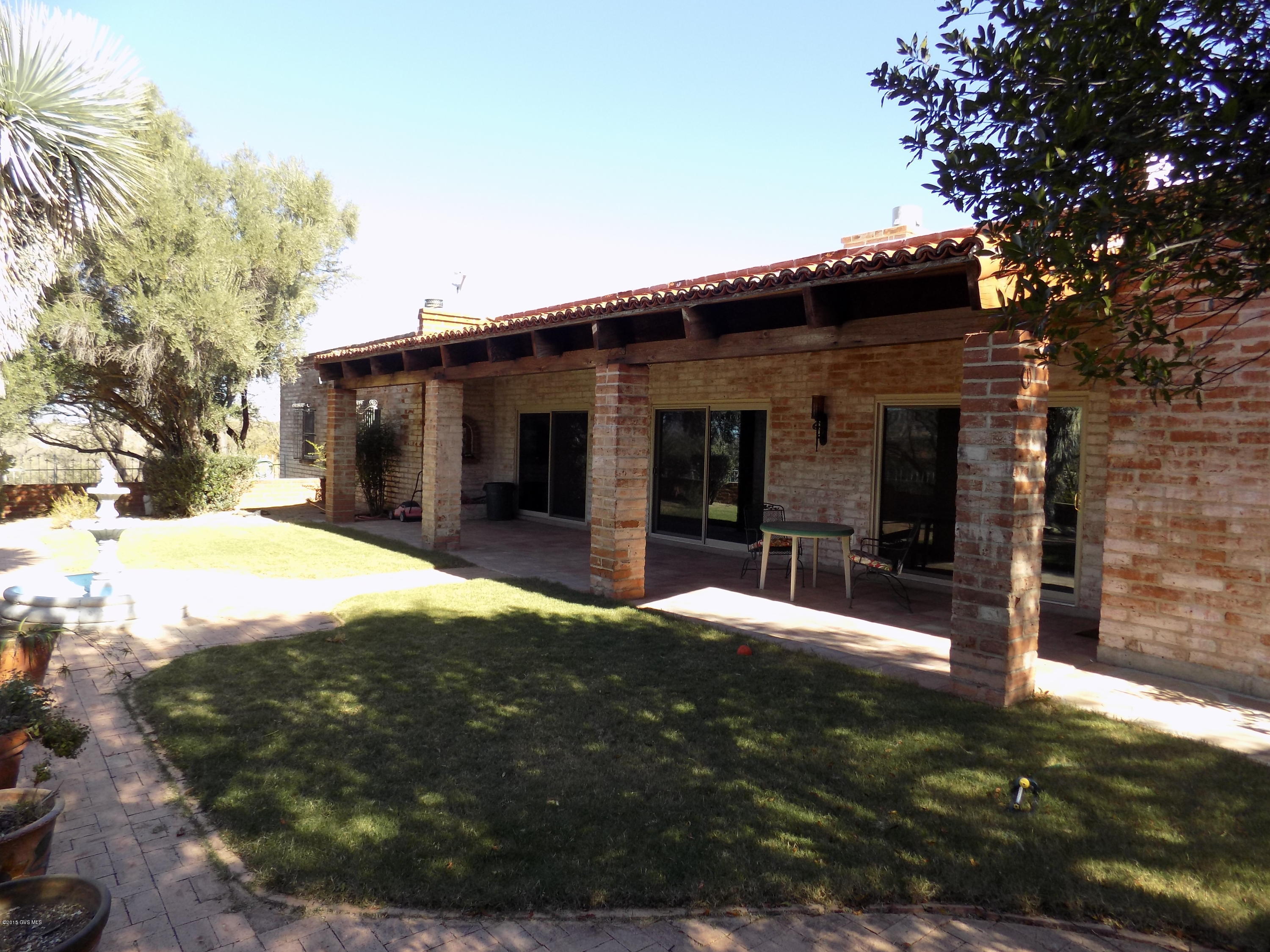 Beautiful burnt adobe territorial home on a bluff overlooking Tubac and the entire Santa Cruz River basin. 360 degree views of the Tumacacori and Santa Rita Mountains. Lovely saltillo tile and living room fireplace. Windows have been upgraded, 2 car garage plus an attached guest quarters. Horse facilities + green house!