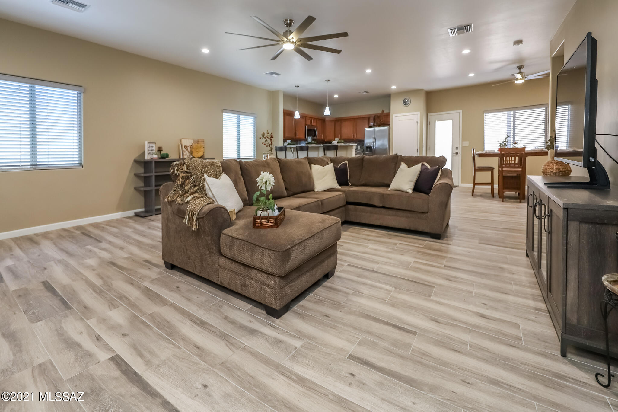 Look no further! This home invites you in with a gorgeous paver driveway, and extended paver patio with a pergola. Enter through a custom iron door to this 3 bedroom 2 bathroom. Open floor plan with wood plank porcelain tile throughout the home. Granite countertops with stunning back splash in the kitchen.  Minutes for Pima College, U of A and Down town. This home will not disappoint....a must see!