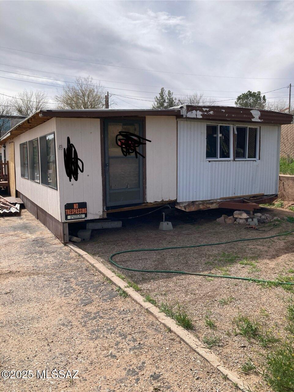 Owner carryback option w/15k down. Permit with city and refurbish!! 2 lots located on a hill with a180-degree, MILLION-dollar, panoramic view. Single wide with a stick addition situated on one lot. 2 stick framed sheds with possible tiny home rehab? 1 stick framed shed is on each lot. On the empty lot another MH unit may be added, making this into a possible 3 income property. New bathrm items, NEW electric panel box/electric throughout, windows. French doors stay. 6k new Roof estimate, Interior doors stay. Work needed, permit with Benson. (work done was not permitted) leveling unit, paint, 1 window and door added, closets 2x4's, drywall, insulation and mud, 1k of the exterior wood stays. Heater works. 25k of items are done AND/OR staying, REF/W/D/STOVE. Handyman Special! AZ. Agent is Own