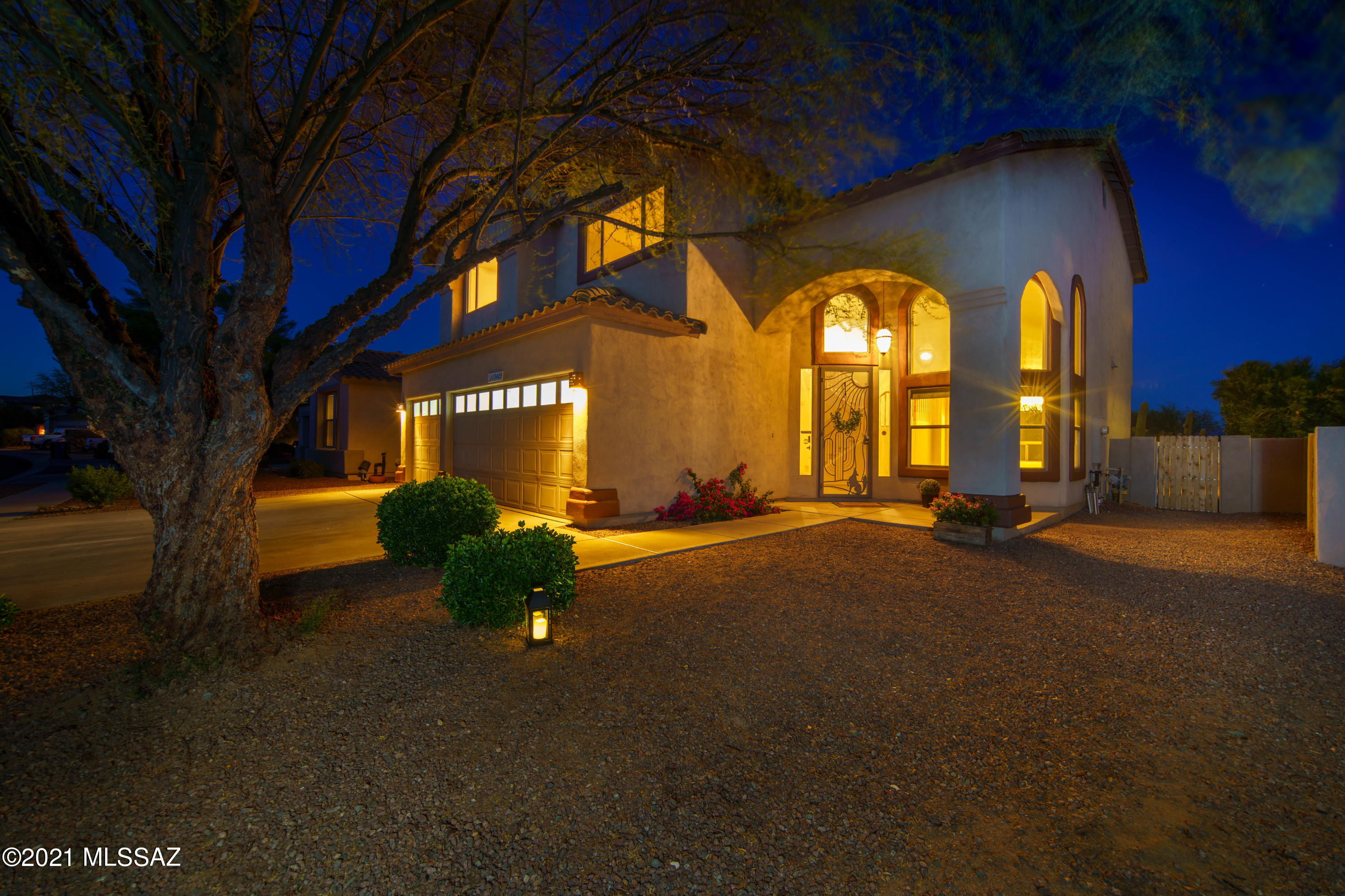 This beautiful home has it all including breathtaking Santa Rita Mountain views!  Spacious and airy, this home features large tiles and carpet on first floor, a grand stairway to all bedrooms upstairs, ceiling fans, soaring ceilings, a gas log fireplace, and 3 bedrooms/2.5 baths.  No neighbors behind you, in a gated community with access to lake; and walking distance to the clubhouse, schools and minutes from shopping.  There is also a wonderful Tuff Shed building in the back yard to house your lawn mower and yard tools.  The spacious 3 car garage is another bonus.  The grand front entry has a custom security gate.  There is also a security gate going out to the back patio.  A large doggy door is installed in the laundry room with access to a gated dog run area.  With all fresh paint inside and new kitchen countertops, this gorgeous DR Horton home is move in ready!  All of this in the beautiful Rancho Sahuarita neighborhood with parks, (one just a short stroll away), pools, activities, and access to the lake for fishing.  There is a grocery store, restaurants, and banking just minutes away.  This gorgeous home won't last long!