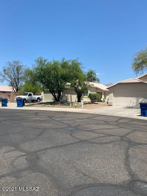 A terrific property with benefit of location! Just one block north of Ina Rd, it's close to multiple shopping choices, Tucson Mall, Walmart, restaurants, access to 1-10 within 4 miles. Near medical facilities, 2 hospitals.  Walking distance to Pima College, YMCA, ballparks, dog parks.  Ideal for a young couple, retirees of college students.  Low maintenance in a quiet gated community makes it a great choice.  private with common area on 3 sides.  New exterior, interior paint.  Well maintained. New carpet and waterproof, wood-look plank vinyl.  Mini blinds throughout.  Storage shelves in 2-car climate -controlled garage. One bay used for dog enclosure will be removed at buyer's request.