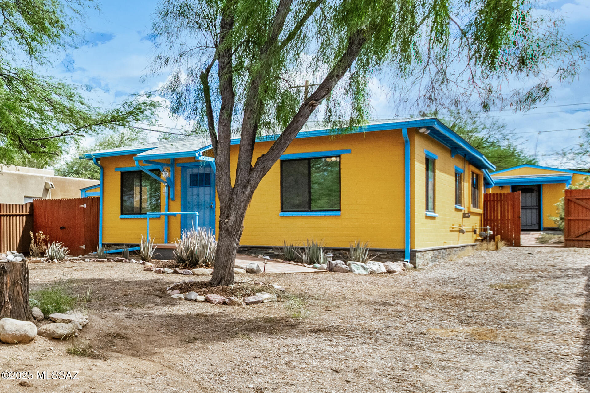 Meticulously updated home with guest house in central Tucson. The main home offers 2BR with a den near the UofA featuring extensive upgrades inside and out including finished guest house/office. Enjoy a bright living room with new electric fireplace, modern kitchen with granite counters, new cabinets, and appliances, plus fully renovated bath including double sinks. Energy-efficient mini-splits in every room, new roof, insulation, tankless water heater, newly screened in porch, storage  and fresh paint add comfort and peace of mind. The remodeled guest house offers kitchen, bath, new roof, windows, flooring, perfect for an office or guests with separate entrance. This property is completely walled in, gated, new walkways, storage shed and an electric EV or RV. So much to offer!