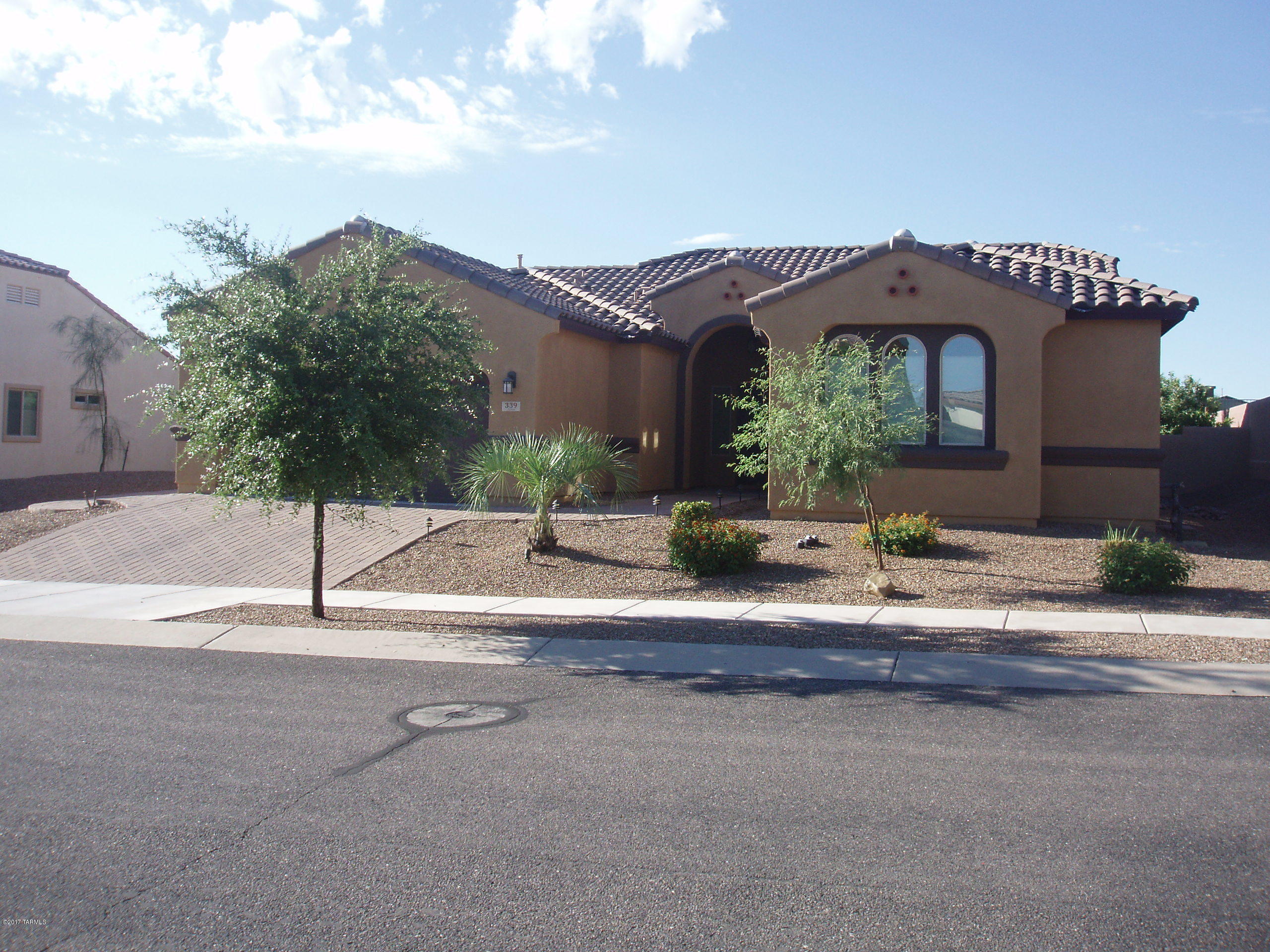 Located on the southern end of Rancho Sahuarita, this 2012 built, 4Br 2.5 ba open concept ranch style house is a must see. As part of the Estancia Del Corazon gated community you are close to many Rancho Sahuarita attractions, including 3 pools, main gym, an a lake. Schools plus shopping plaza are less then a mile away. The beautiful private landscape (overlooks a wash) includes a small section of grass, a large patio area, 3 fruit trees(apple, orange, lemon) and a fire pit for the cool nights ahead. Nice finishes throughout include Granite counter tops, stainless steel appliances, washer/dryer, water softener, double vanity in both bathrooms, split bedroom floor plan, overhead fans in both main living areas and master suite.