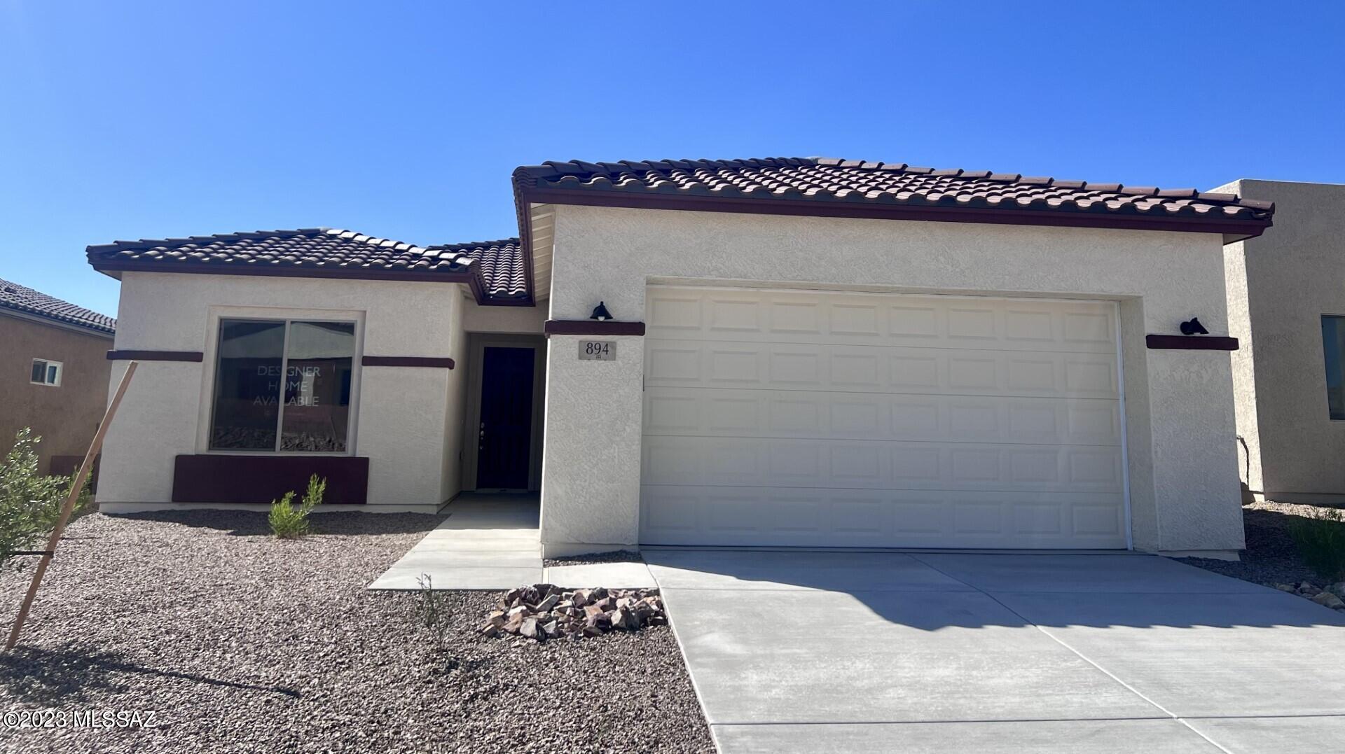 Beautiful 2 bedroom with den, open floor plan with many upgraded features. Full patio across rear of home, 4' garage extension, 8' interior doors and 10' ceilings, and the large master closet is always a favorite. Lots of natural light from all the windows across the back of the home framing the Santa Rita Mountain views! Front and backyard landscaping is included. This homes has it all!! (Rendering, photos, and videos are conceptual)