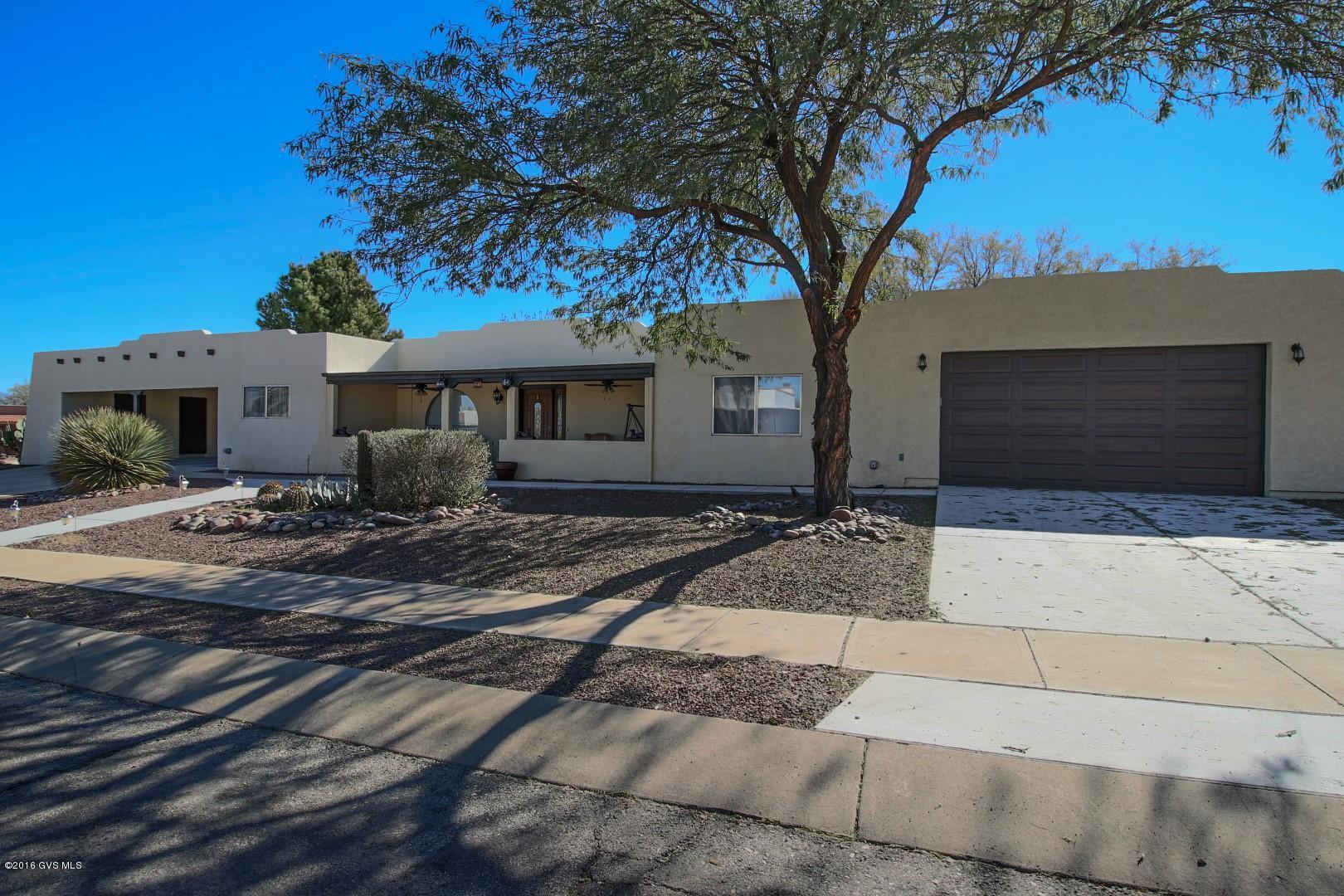 Enjoy your evenings sitting on the back newly tiled patio watching the setting sun change the color of the Santa Rita Mountains. This freshly painted home with many upgrades is situated on a large corner lot. Back patio has a water/fire fountain that will enhance the ambiance of your outdoor evening entertaining. Added 28'x32' garage/workshop with 8'x16' overhead door, and tiled covered front patio dramatically changed the face of this home. Large pantry and laundry room with drop down table, 18'' tile throughout, reverse osmosis, and skylights. Storage, storage, storage... did I say storage? Don't miss out on this rare gem in Green Valley. This home has GVR!