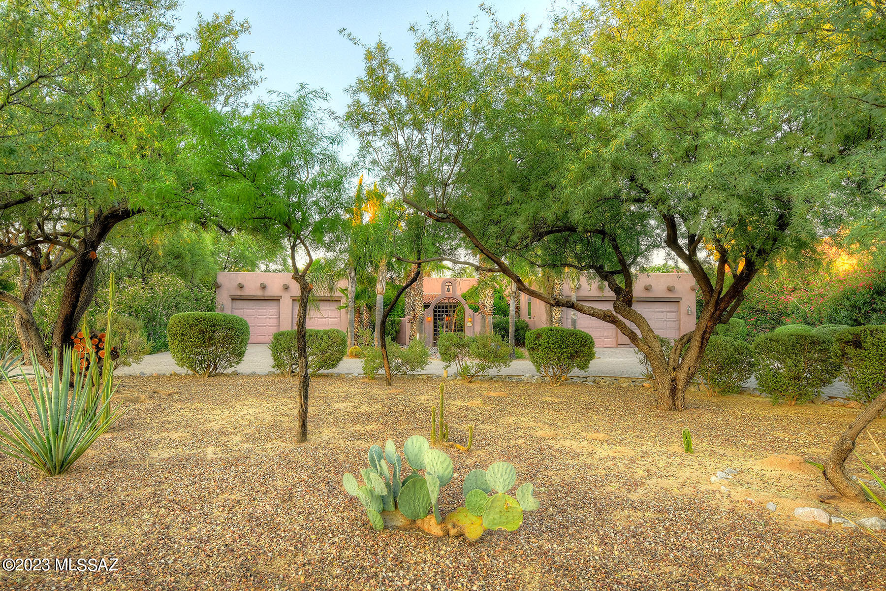 STUNNING Santa Fe in the HIGHLY DESIRABLE Oro Valley Estates. This ORIGINAL OWNER property has an UNSURPASSED LEVEL of LUXURY & EXQUISITE ATTENTION to DETAIL. 3 Bedrooms, 2.5 Baths, Office/Den, HUGE 4-CAR GARAGE all overlooking PUSCH RIDGE & the 14th Fairway of the OV CC!  A Brick Paver CIRCULAR Driveway will lead you to a GRACIOUS & WELCOMING Courtyard/Fountain.  Inside, you'll find a Split Floorplan with a Large GREATROOM & Cozy Beehive FP.  Dining Room w/WOOD BEAMED Ceilings & BUILT-INS Galore!  GOURMET Cook's KITCHEN has SS Appliances & Plenty of KNOTTY ALDER Cabinetry.  PLANTATION SHUTTERS & Solid 8FT Knotty Alder doors thru-out.  OWNER'S SUITE OFFERS a LUXURIOUS Soaking Tub & Custom Tile work all Overlooking a RESORT-LIKE setting w/Sparkling POOL, Spa & Built-in BBQ.  WELCOME HOME!