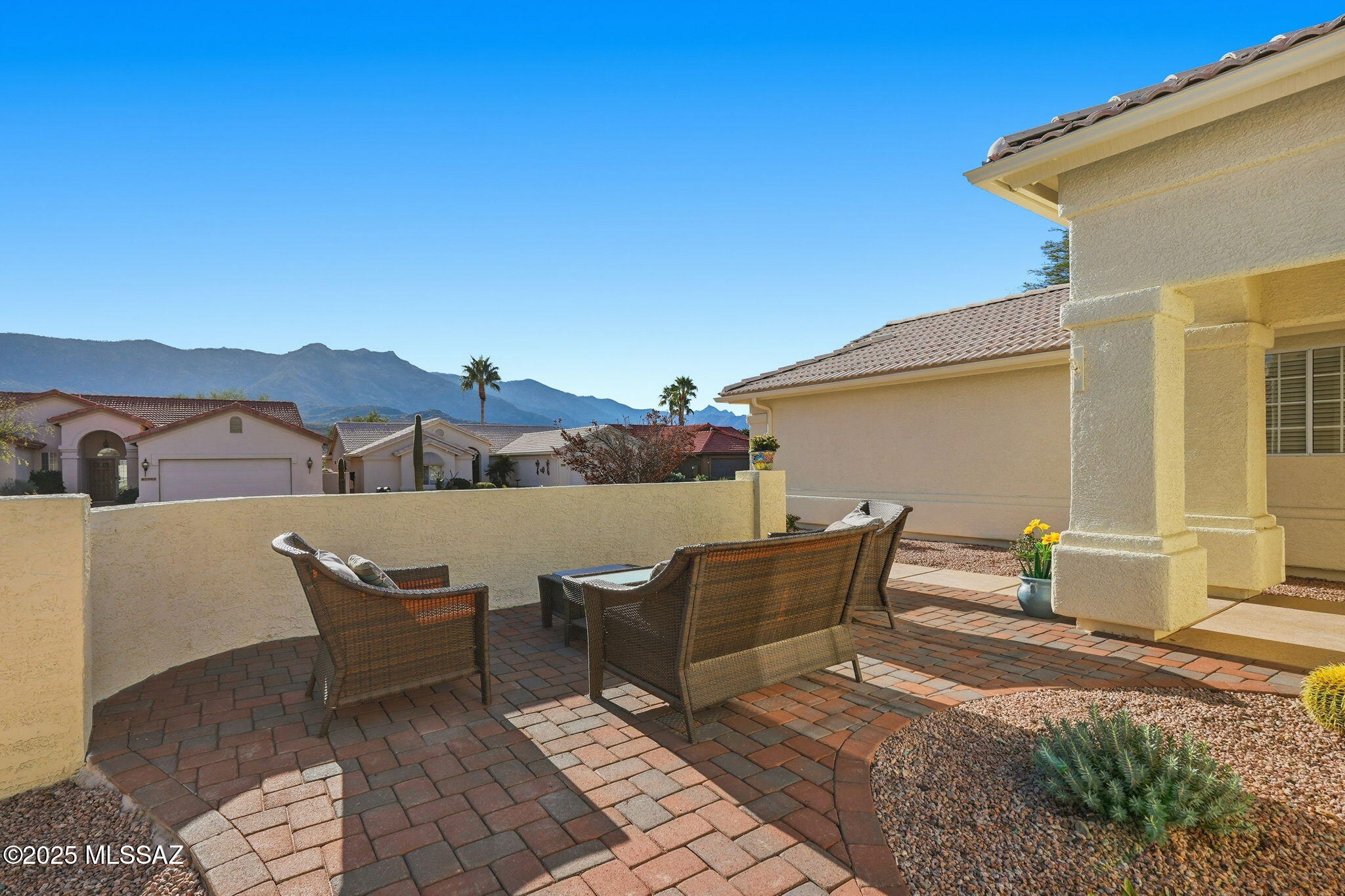 Catalina Mountain views from front patio of this Diego floor plan in SaddleBrooke. HVAC (2025), roof underlayment (2022), updated bathrooms w/granite (2025), front patio & landscaping (2025), & exterior paint (2025). 2 bed, 2 bath plus den/office. Beautifully updated kitchen - granite counters, a counter-height breakfast bar with stools, opens to family room. The living room & front patio offer beautiful views. Primary suite features luxury vinyl flooring, dual vanities, two closets, & generous bedroom space. Guest room includes large walk-in closet & cozy carpet. Step out back to cozy, private backyard w/full-length covered patio, extended paver patio, citrus & elevated planter w/lush bougainvillea. Lovingly maintained. Move in and enjoy!