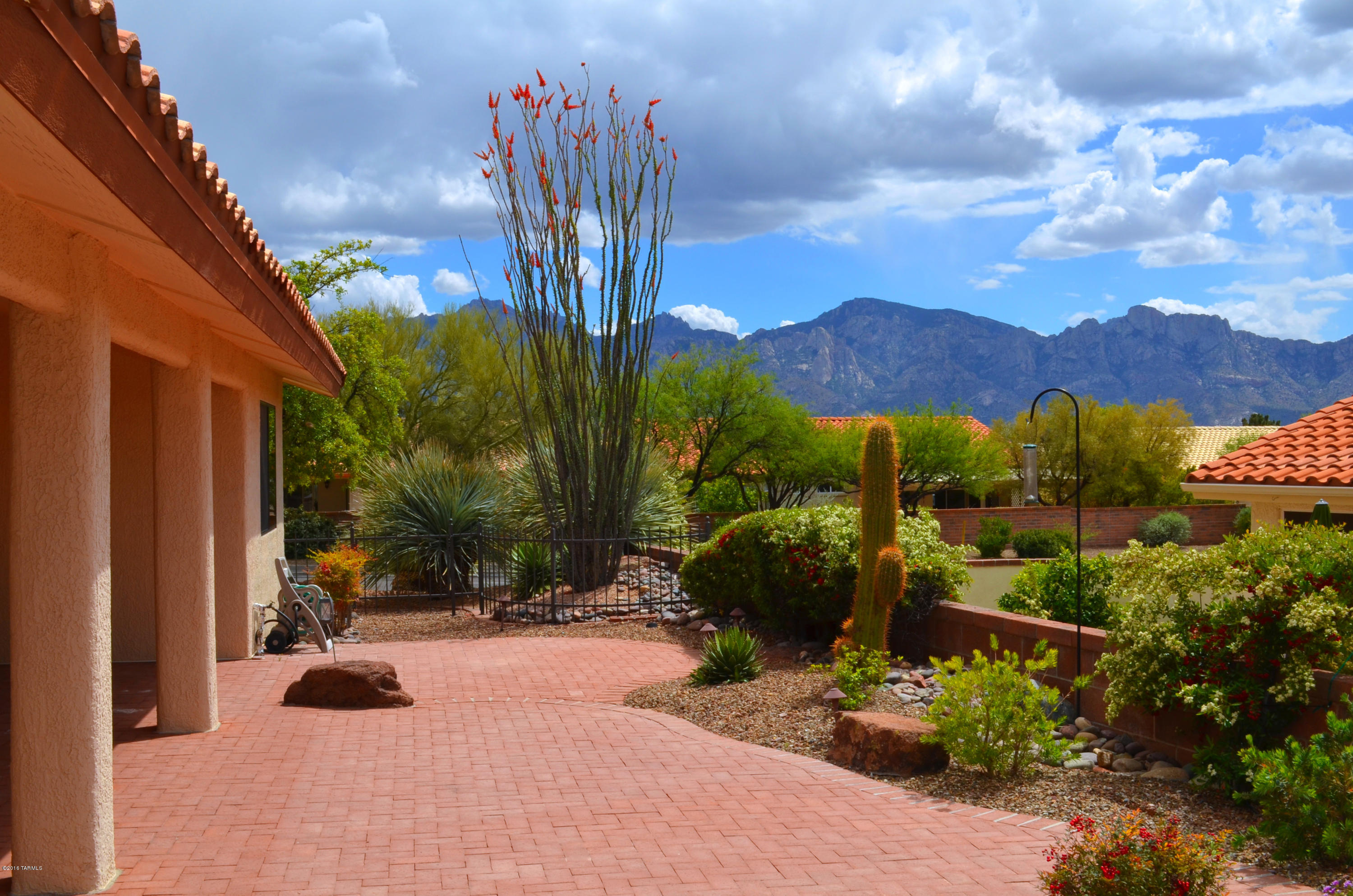 There is Plenty to Love about this Crown Point Model with Catalina Mountain Views and a Fabulous 2 Bedroom Plus Den Design. Bright Open Kitchen with Solid Oak Cabinets, Wine Cooler and Sunny Breakfast Nook. Open Family Room off of Kitchen. Living and Dining Rooms with Vaulted Ceilings for Entertaining. Spacious Master Suite with Bay Bump-out Windows and Walk-in Closet. Generous Master Bath with Soaking Tub & Separate Shower. Split Bedroom Floor Plan for Added Privacy. Large Laundry Room with Utility Sink & Cabinets. 2 Car Garage with Storage Cabinets. Resort Quality Outdoor Living Space Featuring Catalina Mountain Views, Shady Covered Porch, Extended Brick Paver Patio, Cascading Water Feature and Meticulous Landscaping. Make this house your Home by Adding Your Own Decorating Style.