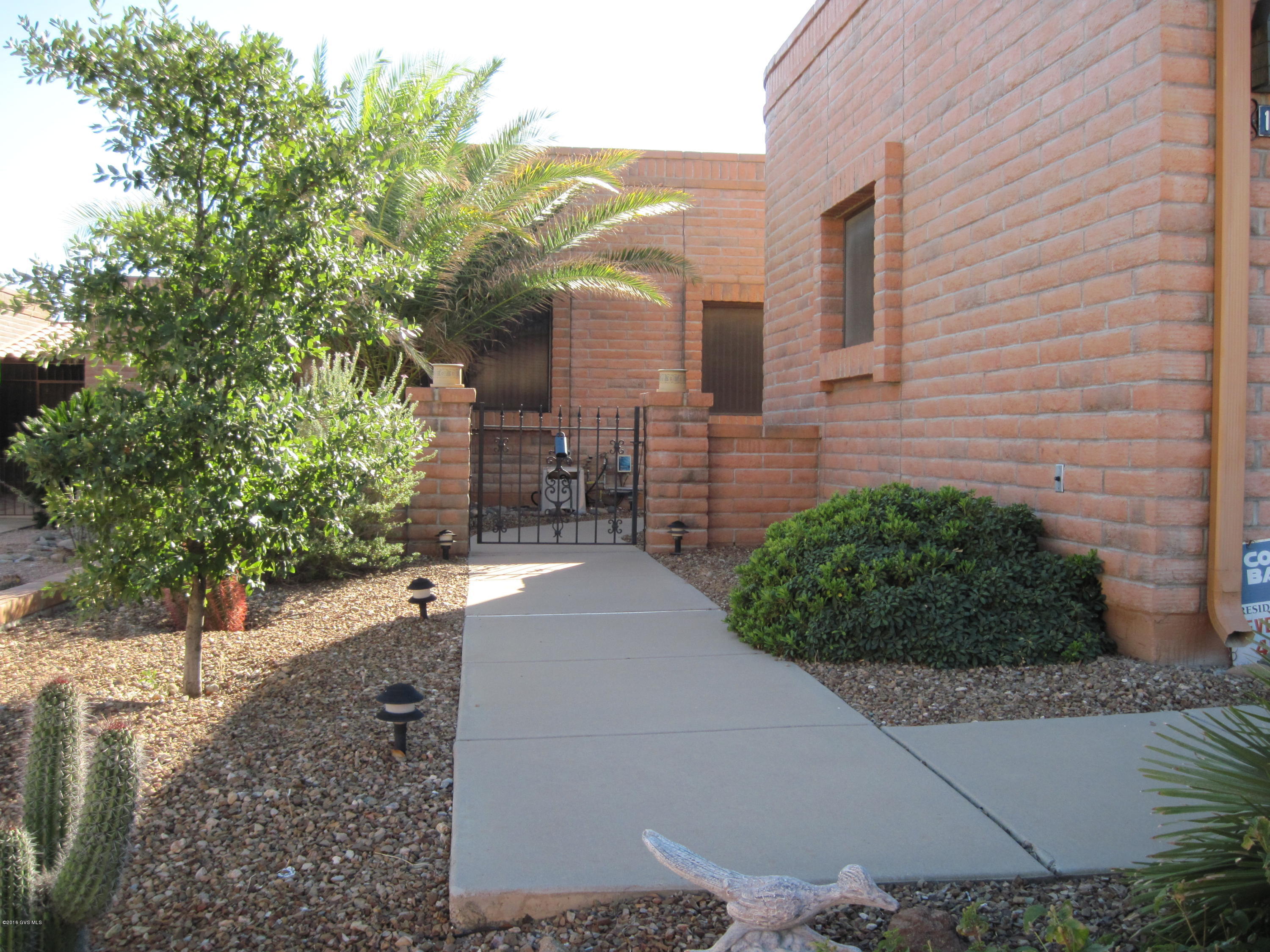 Here's the very popular Ensenada floor plan featuring 2 large bedrooms + a good sized den + 2 bathrooms + 1750 square feet of living space and a MTN view to enjoy from your private patio!!! What more could you ask for??? Well, this is an end unit townhome which provides extras windows with one over the kit sink and one in the dining area - lots of light! Kitchen features newer appliances - microwave is also a convection oven - plus pull-outs in the cabinets and reverse osmosis. A new heating & air conditioning system was installed in 2001 and a new roof (regularly maintained since) in 2005. Enjoy the hot water circulating system for hot water in your shower quickly plus a Zeta Rod water treatment system. Did I mention the private patio with MTN view - you can almost see Tubac!