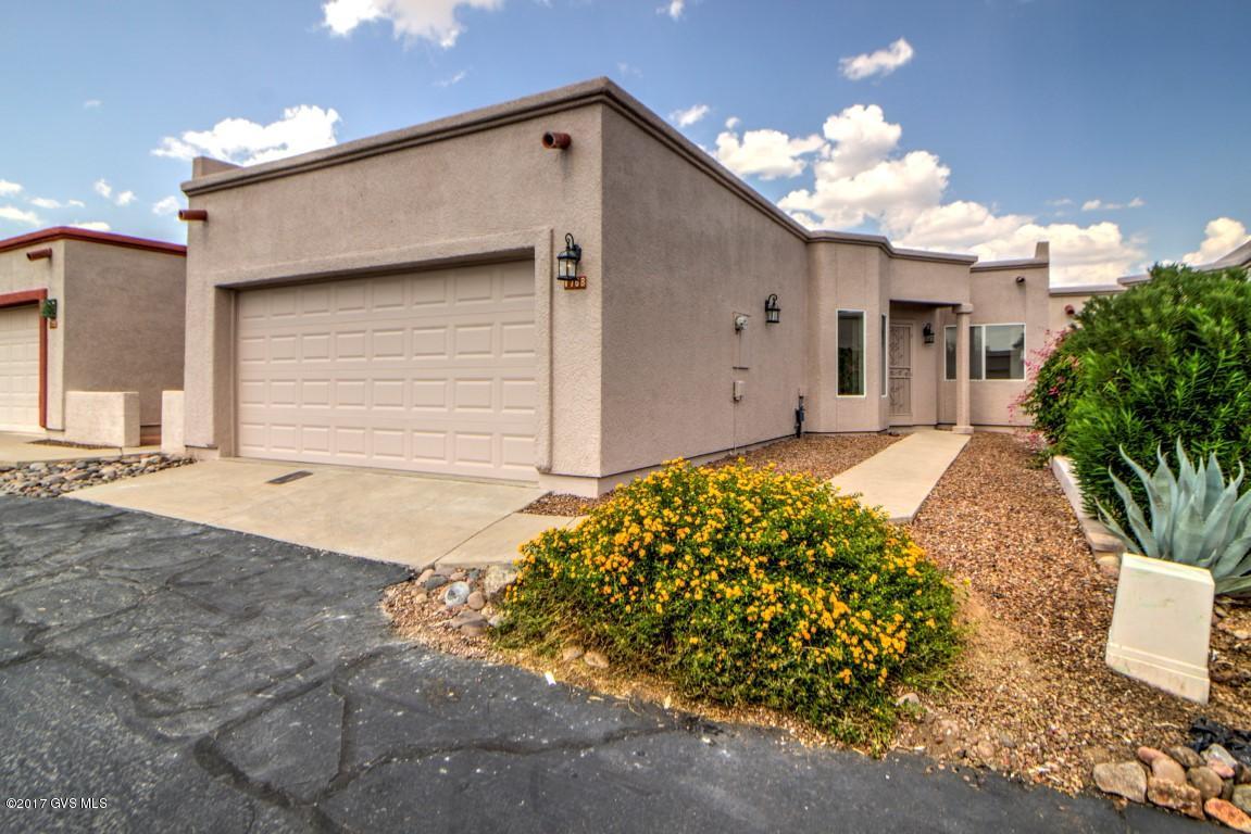 Beautifully renovated townhome with 2 bedrooms, 2 baths and 2 car garage. This home features a large open great room with 12+ foot ceiling leading to sliding glass door to a good sized covered Patio. Fully appliance kitchen with adjoining breakfast nook. Office between the kitchen and garage. Guest bedroom includes a Murphy bed, Laundry area including washer and dryer located in the rear of the garage. The backyard borders open space and even offers some mountain views. You will truly appreciate all the wonderful updates including: freshly painted inside and out, new flooring throughout the home, renovated kitchen and baths, granite kitchen counter tops. Located on a quiet street yet easy access to shopping and highway. Ideal year round home or seasonal getaway.
