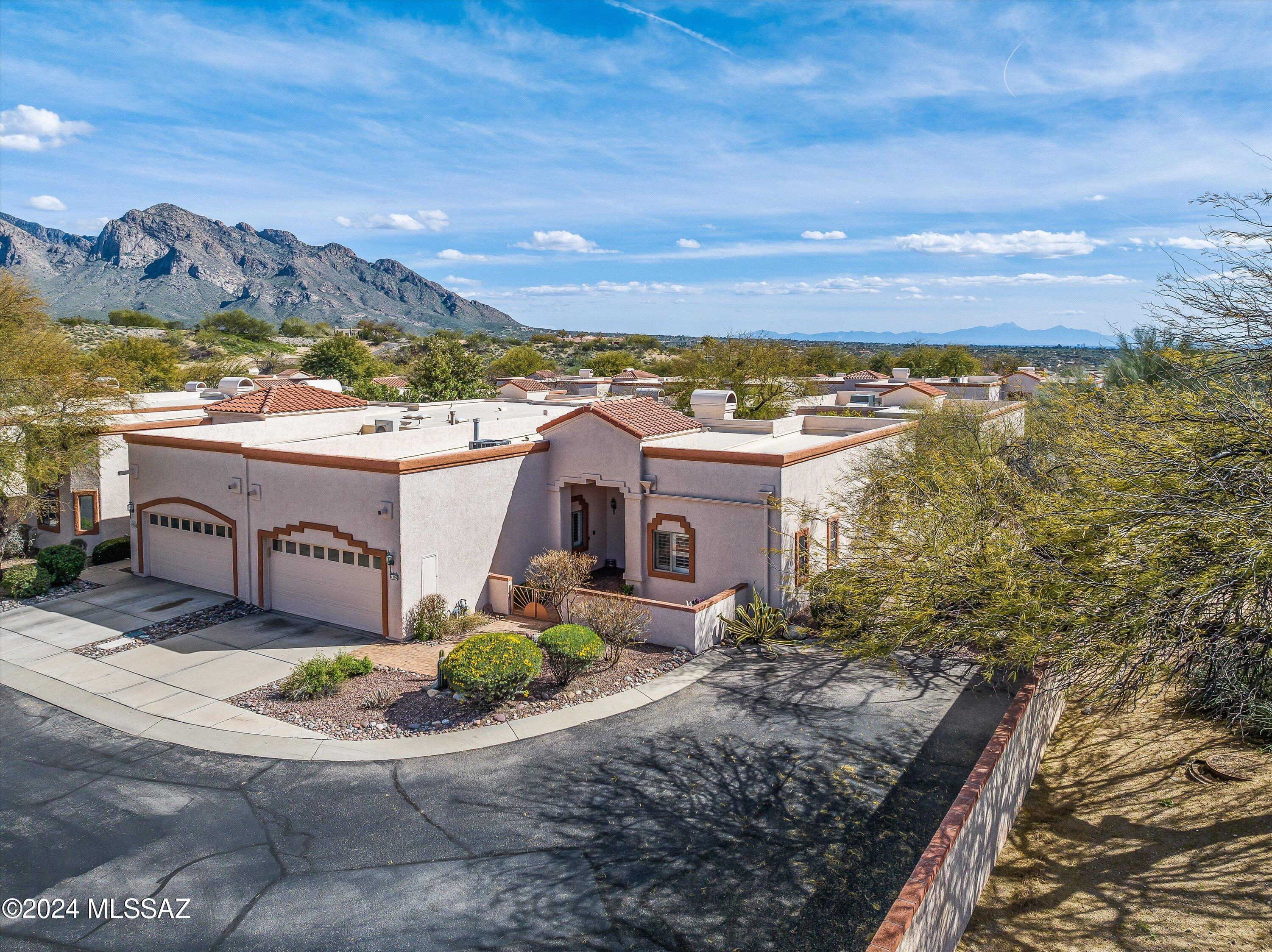 Gorgeous townhome located in gated community in the heart of Oro Valley~is selling TURN-KEY!  Outstanding custom features set the tone for comfort in this 3 bedroom 2.5 baths w/amazing floor plan and designer touches throughout. Great room w/high ceilings, natural light and floor to ceiling stacked stone gas fireplace. Primary suite is bright and spacious w/plush carpet, walk in closet updated bathroom you'd expect to find in a million $$ home. Kitchen w/ breakfast bar, quartz counters. Inviting backyard, gazebo, brick pavers, fountain & cheerful flower beds. Enjoy a short golf cart ride to El Conquistador Golf Course, recreation, tennis & aquatic center. Conveniently located near shopping & restaurants. Quick closing available. Must see today!!