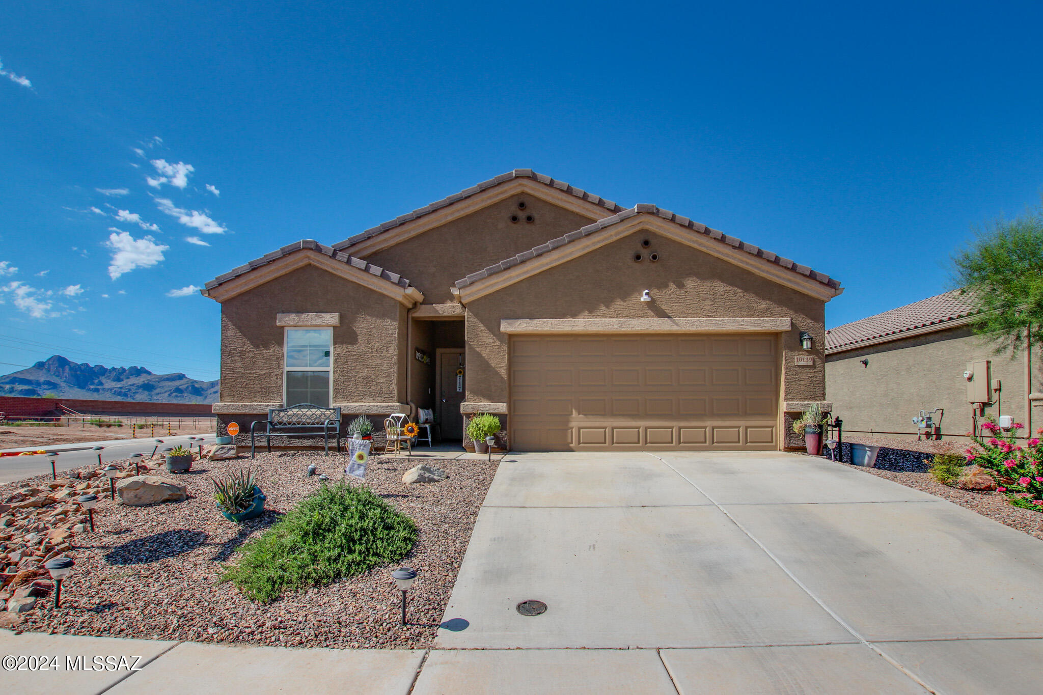 Discover the desirable Saguaro Bloom community with this 4 bedroom, 3 bath home, featuring an open kitchen concept with dining and living areas, granite countertops, island, stainless steel appliances, gas range, updated lighting, and pantry. Enjoy your morning coffee watching the sun rise above the majestic mountain views. Home features upgraded fans, spacious primary bedroom and walk-in closet, dual vanity sinks, updated half bath vanity, tankless water heater, covered back patio with extended pavers, manual and timer drip system in backyard. Entertain in your fully landscaped backyard with covered Pergola. And NO rear neighbors! Community features pool, spa, splash pad, basketball court, park and playground.  Don't miss out on making this home your dream come true!