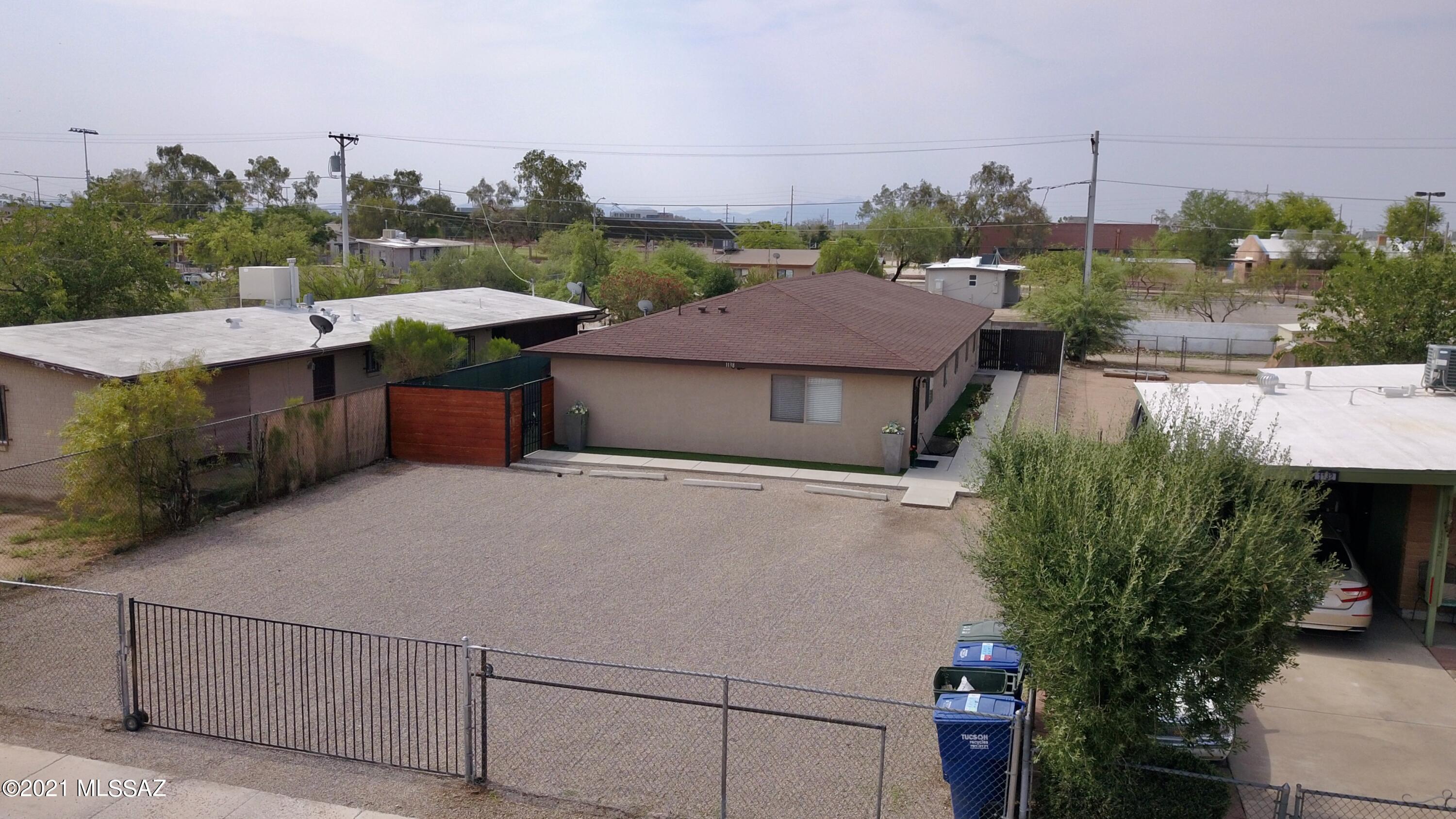 Fully gated duplex near downtown Tucson with no HOA! Front unit has 2 bedrooms, 1 bath & will be sold VACANT, perfect for an FHA buyer who wants to live in one unit & rent out the other (HOUSE HACK). Rear unit has 3 bedrooms, 2 baths with an open concept floor plan and a signed tenant lease through June 2022. Both units have concrete floors throughout, bathrooms have been remodeled with new granite top vanities, indoor laundry, air conditioning, separately metered water & electricity, private yards with their own storage shed and a block wall for privacy. Located less than 10 minutes away from the U of A, Downtown, shopping malls, restaurants, Silverlake Park & more! Hurry this one won't last!
