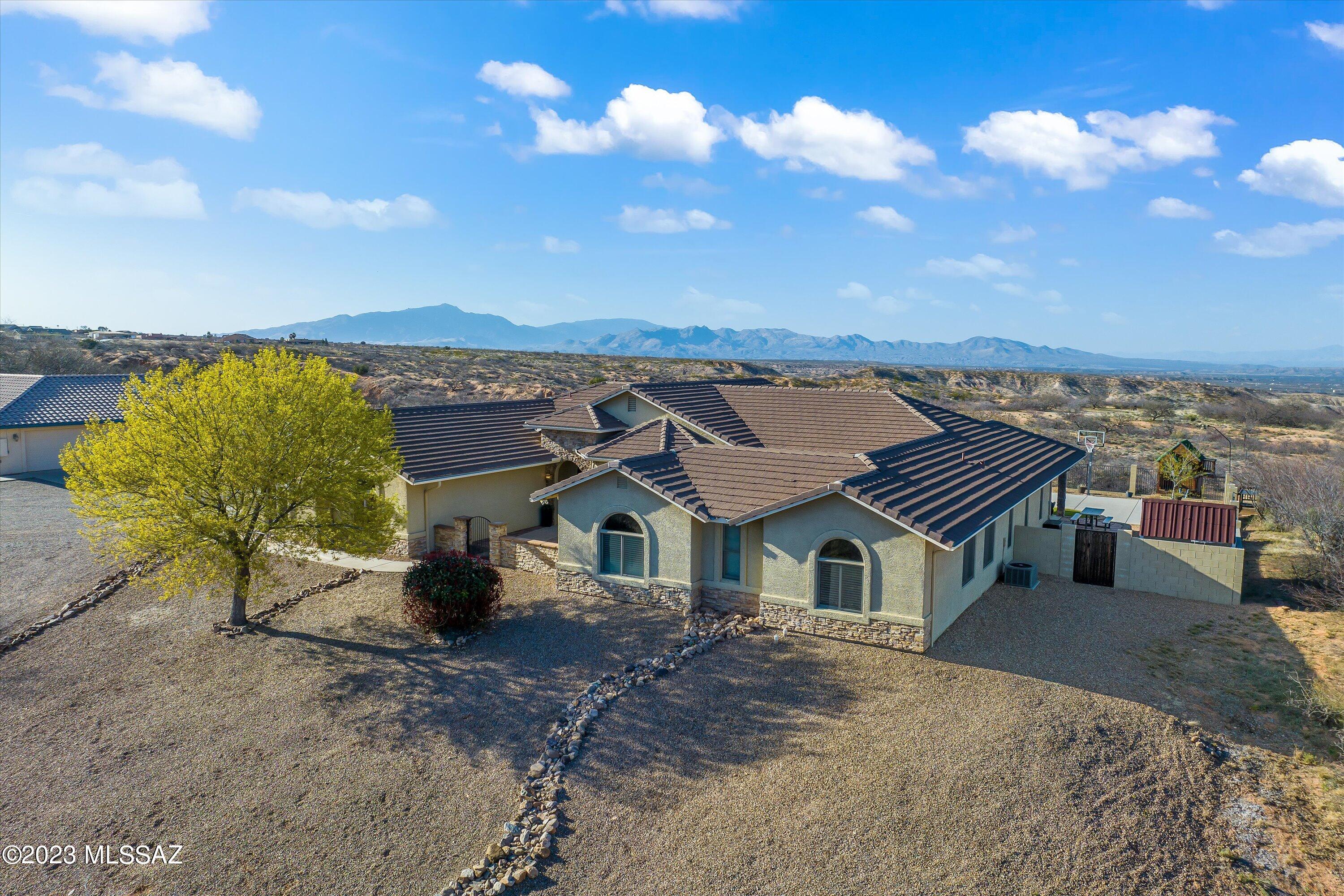 Beautiful custom home with tons of upgrades! Five bedrooms, 4 bath 4002 sw ft with pool and 3 car garage. Peaceful courtyard guides you into a spacious open floor plan. Cozy up in front of the fireplace or gather in the eat in kitchen with granite countertops, breakfast bar island, stainless appliances, gas range, pendant lighting and a huge walk in pantry. Relax in your master suite with private entrance to patio, jacuzzi tub, dual vanities, tiled shower and walk in closet. Extras include: family room with bath and play area, JR master suite, mudroom with storage and seating, laundry room with utility sink, epoxy garage floor, reverse osmosis system, newer water heater and garage doors, plus brand new paint. Relax in your resort like backyard with pool, covered patio, & gorgeous views.