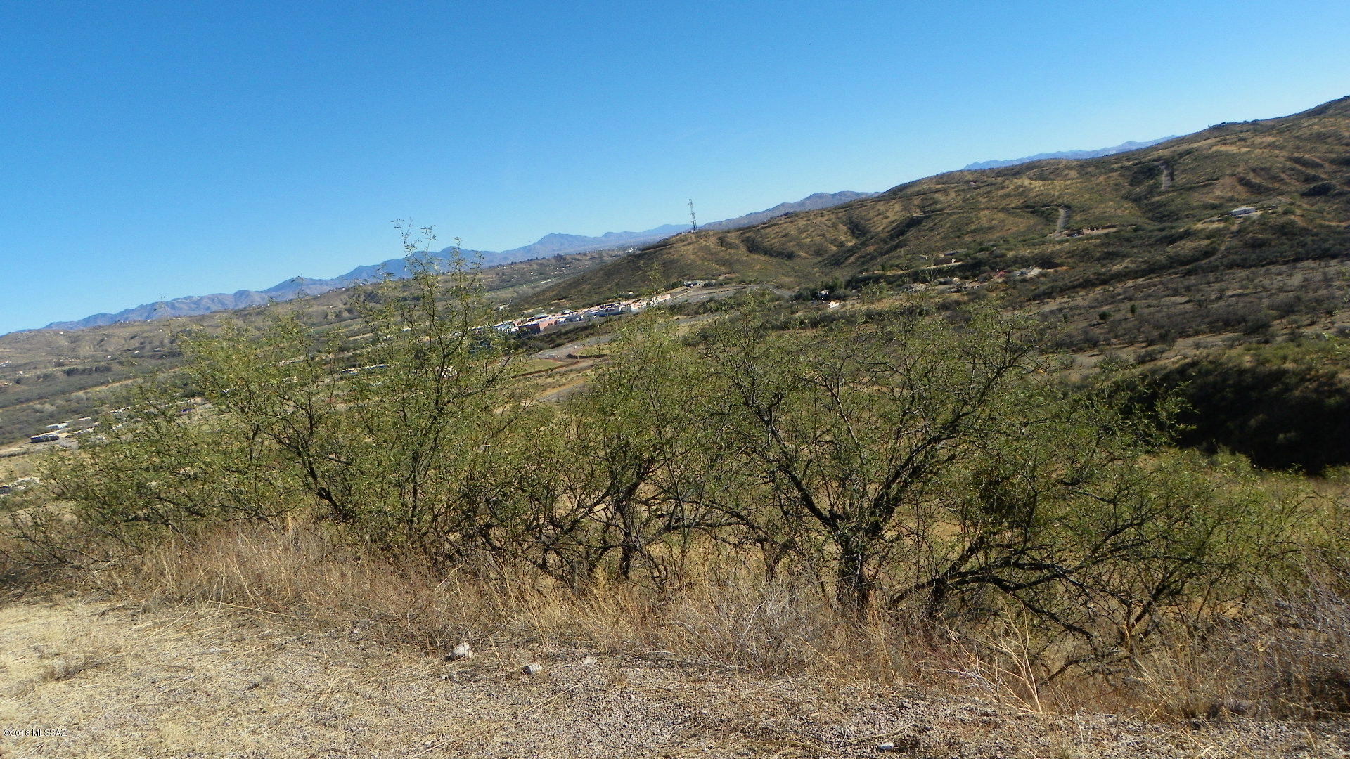 Residential lot with lots of homes nearby.  Paved road, great views, close to schools and highway entrance.  Downhill slope. Utilities electric and water should be at the street.