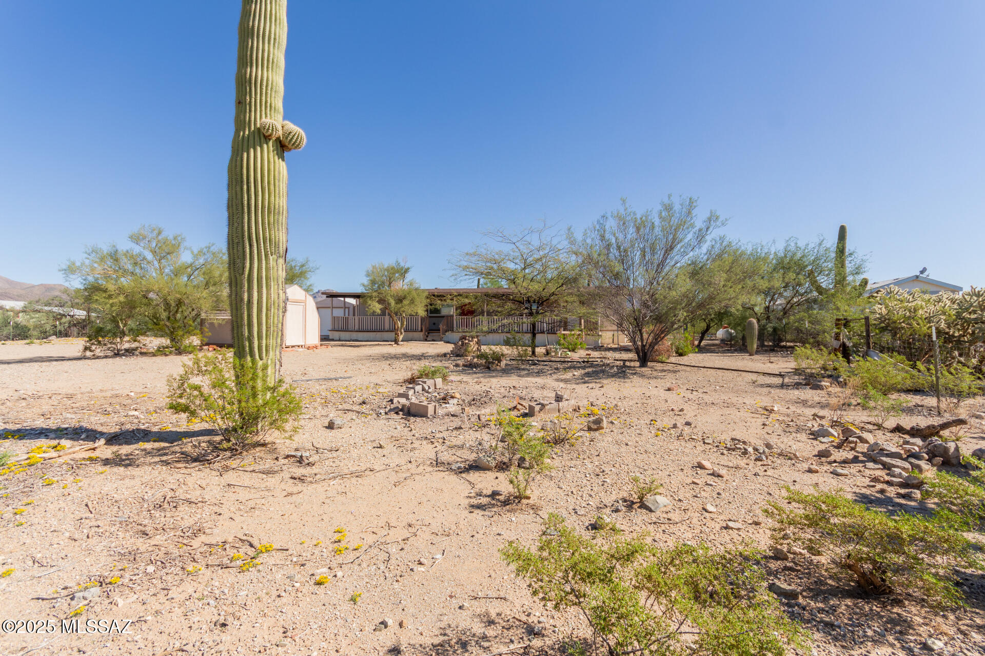 Seller to accept or counter offers between 254900-264900 Beautifully remodeled 3 bedroom, 2 bath home situated on 1.5 acres of peaceful desert landscape! This spacious 1,536 sqft manufactured home offers a bright open layout with all-new finishes throughout. The stunning kitchen features crisp white cabinetry, new countertops, stainless steel appliances, and a large picture window framing desert views. Enjoy relaxing under the expansive covered front porch or entertain with plenty of outdoor space for RV parking, toys, or even horses — GR-1 zoning allows for rural or homestead living at its best! Property includes a detached garage/workshop with roll-up door and easy access to miles of open desert. Quiet country living just minutes from Tucsons amenities! Move in ready and a Must see!