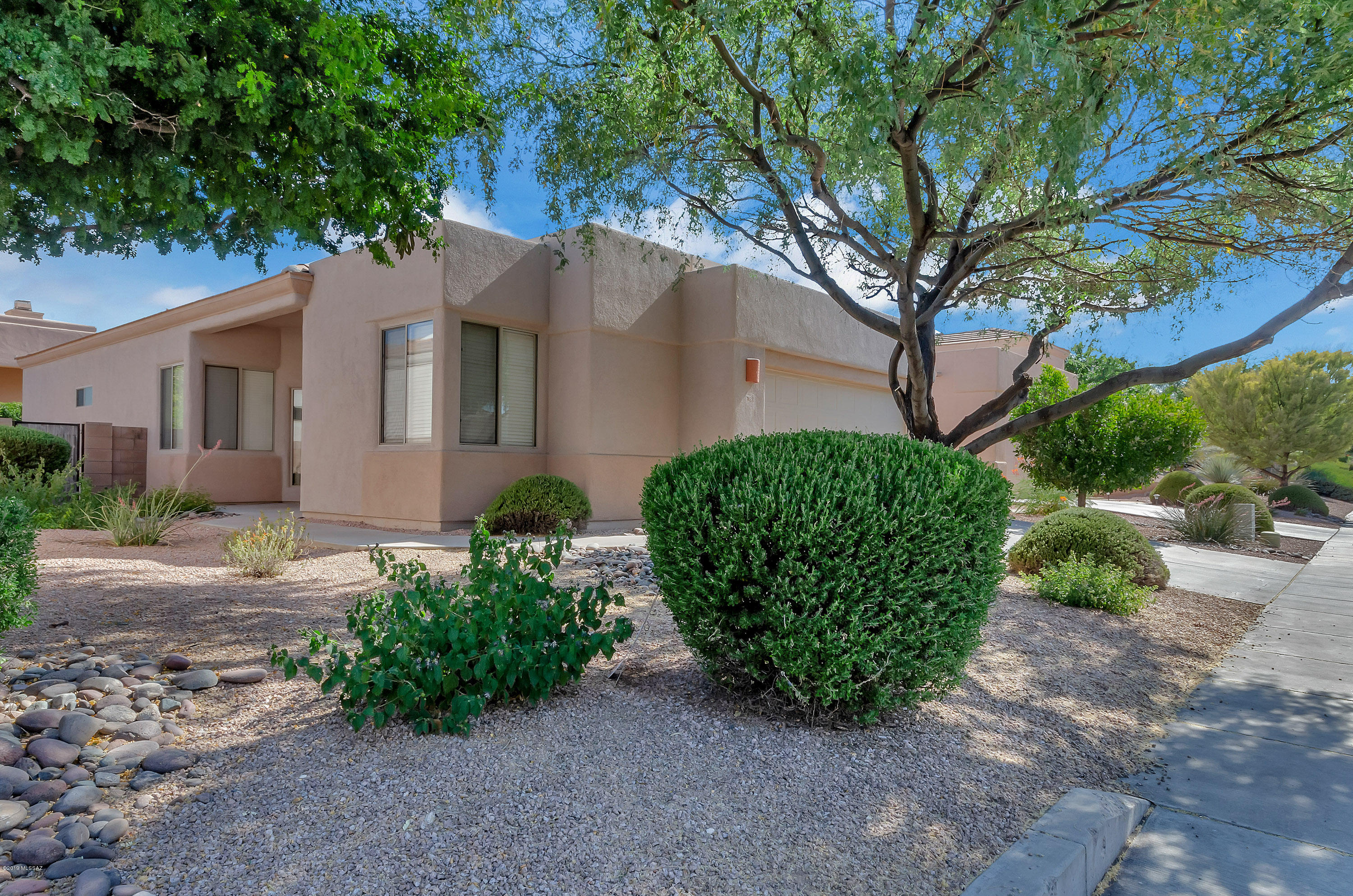 Handsome home in desirable Rancho Esperero. North/South exposure with very private back yard. Freshly painted throughout and new carpet. Clean good looking home with high ceilings. Great room with open kitchen. Split master bedroom floor plan. Awesome location new Udall Park, Sabino Canyon Recreation Center, numerous restaurants and frost gelato! This community has 3 pool, sidewalks and security of little traffic with the gate. Shows well!