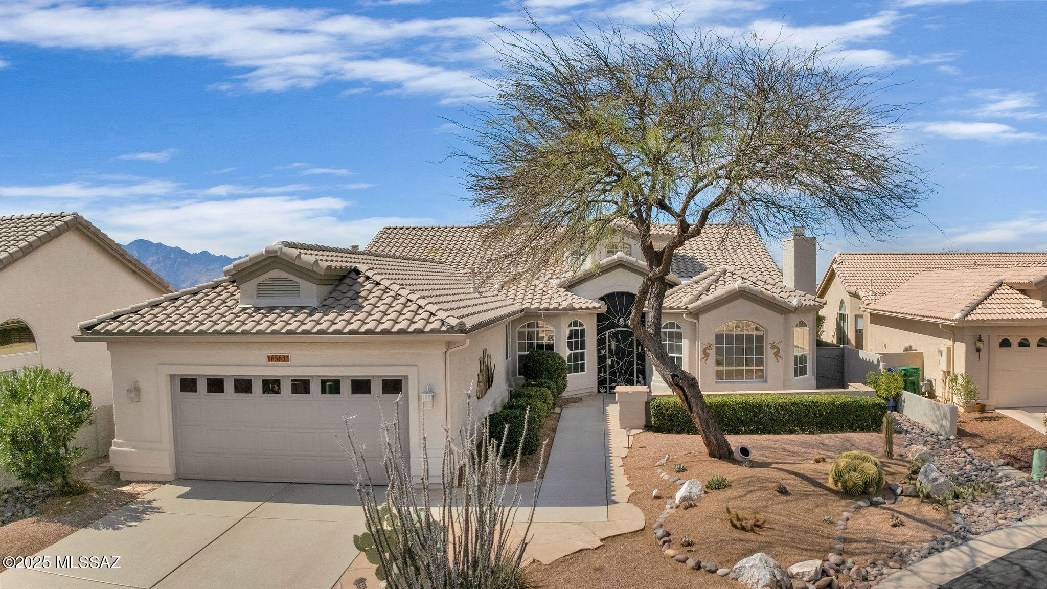 Do you need a Long Driveway on A Cul-De-Sac ?Flagstone Courtyard upon arrival & Custom Entry Door. Spacious Living Areas & Gas Fireplace. Family Room has Wet Bar & Slider to Patio. Remodeled Kitchen with Stoneite Counters, Tile Backsplash, Newer Appliances, Cabinets with slide outs. Handy Powder Room for Guests. Owner's Suite with Slider to Patio. Owner's Bathroom has Walk-in Shower, Soaking Tub & Custom Organized Walk-in Closet. 2 Guest Bedrooms with Closets & Guest Bathroom nearby with Solar Tube. Huge Laundry Room with Cabinets & Desk. 4 Ft. Extended 2 Car Garage has HVAC, W/H, Cabinets & hook ups for sink. Covered Flagstone Patio has Rolling Shade for comfort from the sun. Enjoy a Gated Yard with Beautiful Panoramic Catalina Mountain Views, Putting Green, Rose Garden & 2 Lemon Trees
