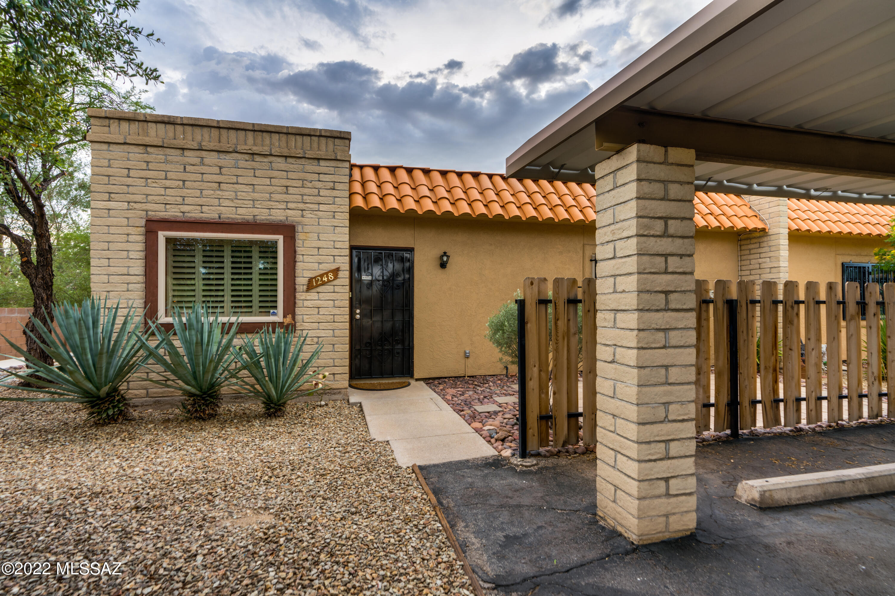Seller will consider offers in the price range of $230,000-$250,000. Quiet end-unit of townhome community. No carpets! Tile throughout. Skylights and lots of closet space in this well-laid out unit. Galley kitchen with newer  appliances features breakfast nook. Plantation shutters in kitchen and dining area windows, as well as at the sliders to patio. Gas fireplace in the living area. Washer & dryer stay. Private covered patio with good-sized storage closet. Water softener for home located at the front water access. Cozy East-facing front yard area has patio pavers to enjoy the mornings outside. Convenient Eastside location close to Marshall Elementary school, shopping centers at Harrison/Old Spanish Trail/22nd St.