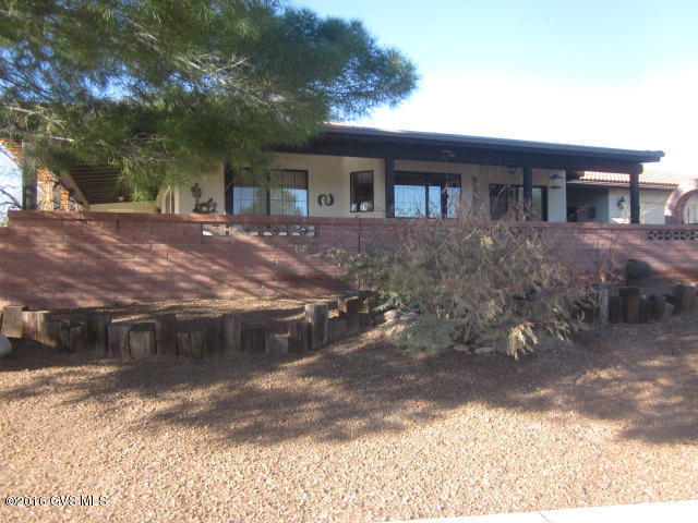 Beautiful free standing home- E patio with Mountain views. 2 BR plus den, 2 BA, 2 wrap around covered patios, bright kitchen with windows, views, quartz counters, eat in area in kitchen with patio doors, formal dining area with more sliding patio doors to the patio. Living area has Bee Hive fireplace. Master BR suite, walk in closets, patio doors, guest BR has expanded sitting room, doors to patio. 2 car expanded garage w/built in and workbench. Also outside storage. Large lot fruit trees, 1900SqFT. All tile floors, master bath, dual sinks, tub and separate walk in shower.