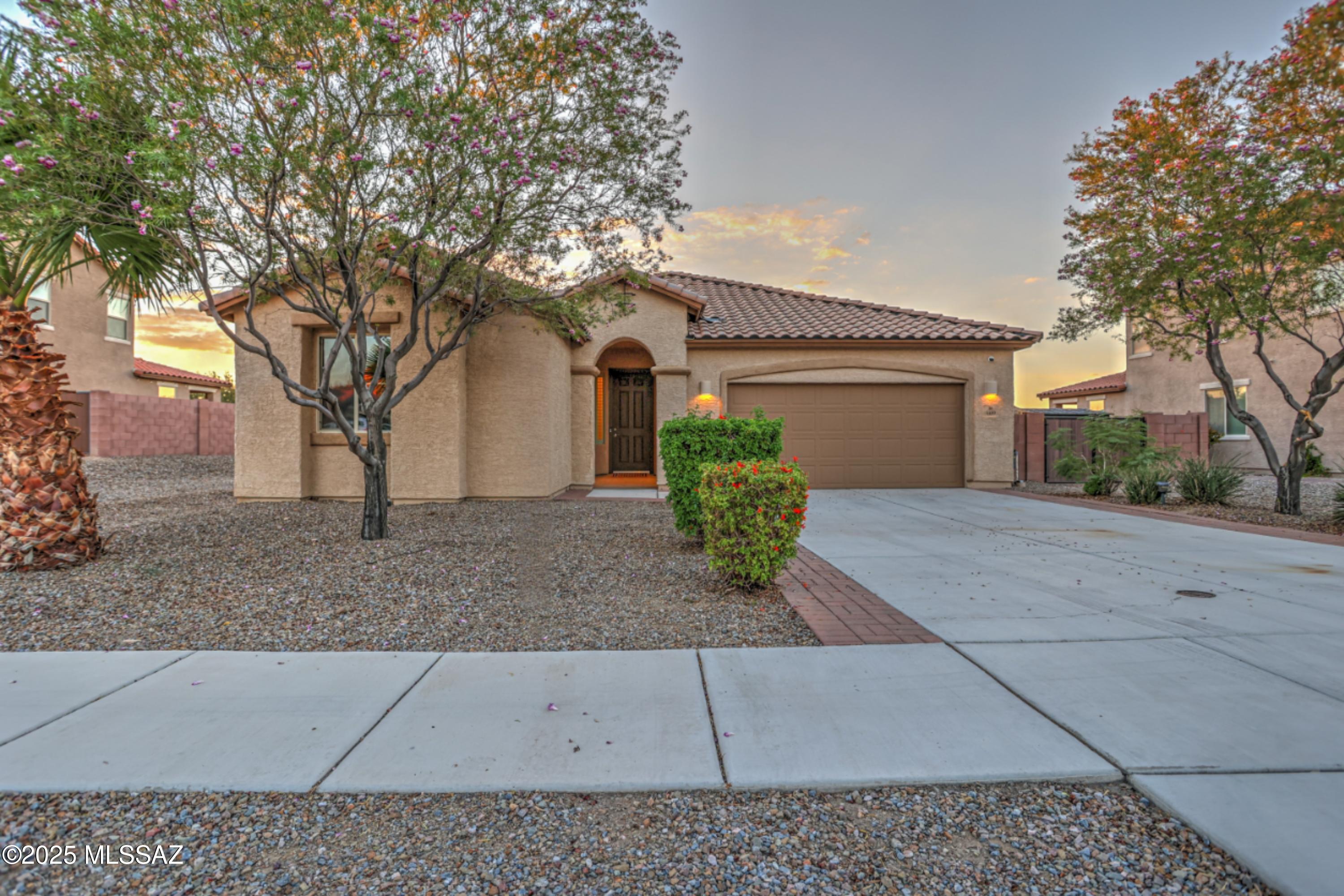 This exceptional, move-in ready home offers thoughtful appointments throughout and premium lot with extra space at the side and desert greenbelt behind.  Modern living is easy and comfortable in this great room floorplan! Spacious Living area opens to the gourmet kitchen which features upgraded appliances suite, an expansive island with seating, a butler's pantry, and granite countertops.  Tile flooring in all main living areas plus brand new carpeting  in bedrooms provides a fresh feel, and the flexible dining room or den and convenient powder room fit a variety of needs.  Split bedroom floorplan means added privacy for the spacious primary suite, which features a dual vanity in the bathroom and a sizable walk-in closet.  The property sits on a large lot with an extra long driveway, an ... expanded side yard with double-gate entry, both practical and functional.  A paver patio in the backyard is an inviting spot to relax and enjoy the gorgeous Arizona sunsets and stunning mountain surroundings. With thoughtful features throughout, this home is ready for you to make it your own.