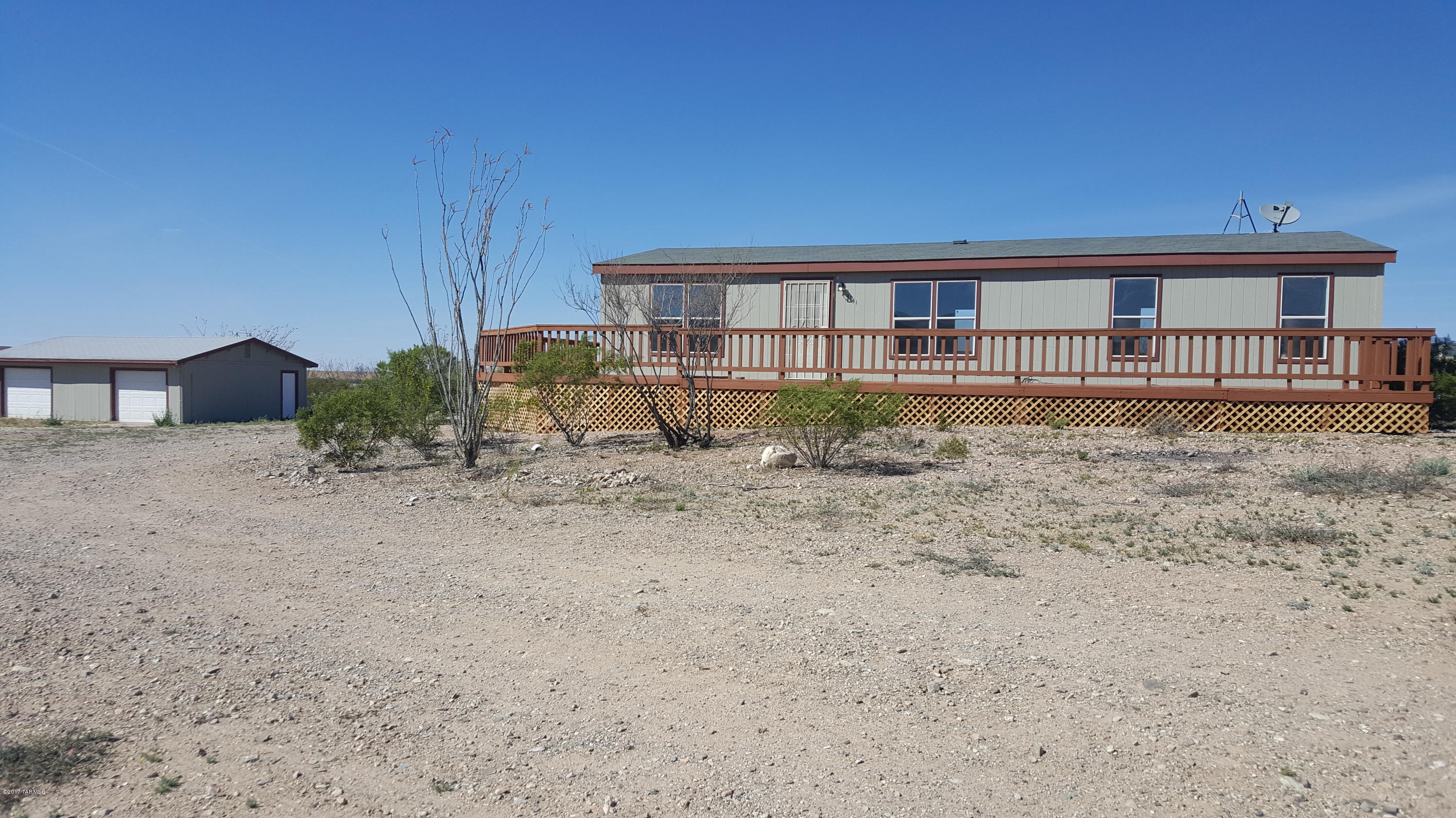 You will not believe the views from the wrap around porch! Don't miss this amazing home on 2 acres with huge 24' x 32' detached garage/workshop. Freshly painted inside and out and move-in ready! New carpet in the living room and new AC in 2016. Brand new railing around the porch and new lattice skirting. Tons of space for horses, toys, RVs, you name it! Incredible sunset and mountain views! 3 Bedrooms and 2 full baths, split floorplan, and lots of living space. Only half mile of dirt road and end-of the road privacy!