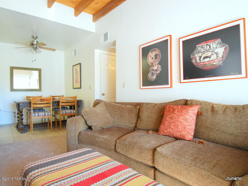 Foothills Condominium in pristine condition. Raised wood beam ceiling in living room featuring corner FP and balcony.  NEW NEUTRAL CARPETING throughout.  Kitchen and guest bath enhanced with new countertops complimenting overall neutral color palette.  NEW ENERGY EFFICIENT AC/HEATPUMP. NEW STACKABLE WASHER/DRYER. Master bedroom with HUGE walk-in closet.  This condo is ready for you to move in !! Most Furniture available for sale under separate bill of sale. Water/sewer and Waste management included in monthly HOA fee.
