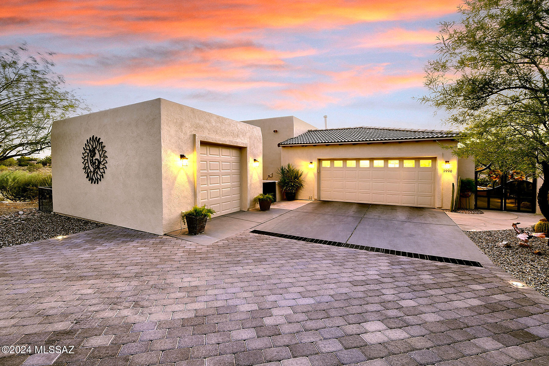 Nestled into the side of a hill, this home is perfectly situated for absolute privacy and features jaw-dropping vistas from every room! Guests are welcomed into the stunning front courtyard through beautiful black wrought iron doors.  The walk-way meanders through lush landscaping and stops at the front entry, where double doors open onto what is possibly the best VIEW in Green Valley!  Stepping inside, the Santa Rita Mountains are front and center and are sure to take your breath away! Visible from every angle of the great room and kitchen, this is the true meaning of the phrase ''Mountain View''! The great room and kitchen are flooded with natural light and dark wooden beams and alder wood cabinetry add drama.  A separate dining area and glowing fireplace add to the ambience. The oversized, wood trimmed sliders leading out onto the patio can be opened for an indoor/outdoor flow while entertaining.  The patio is the heart and soul of this home with its spectacular views and privacy.  The lot drops off into an arroyo with nothing but mountains beyond. Flagstone floors, built in bancos, a trickling water feature and an outdoor kitchen, all add to resort feel of this space.  A meandering side yard that wraps around to meet the front courtyard offers more space for relaxing, gardening or gathering. The master suite has its own access to the patio and more of those views! A walk-in shower, soaking tub and and walk in closet complete your retreat. The guest room with its own bath features a glass block shower and plenty of privacy. The third stall of the garage is separate from the other two and has been previously used as a craft room or studio. With its own heating and cooling, cable TV, and huge window framing the mountains, this space could easily be transformed to meet any need: Grandkids playroom? sewing room? guest casita? or simply use it as an additional garage stall. You will surely be the envy of your friends and family with the amazing location and unobstructed views of this home.  The location combined with the beautiful outdoor spaces and tastefully updated interior are nothing less than PERFECT!