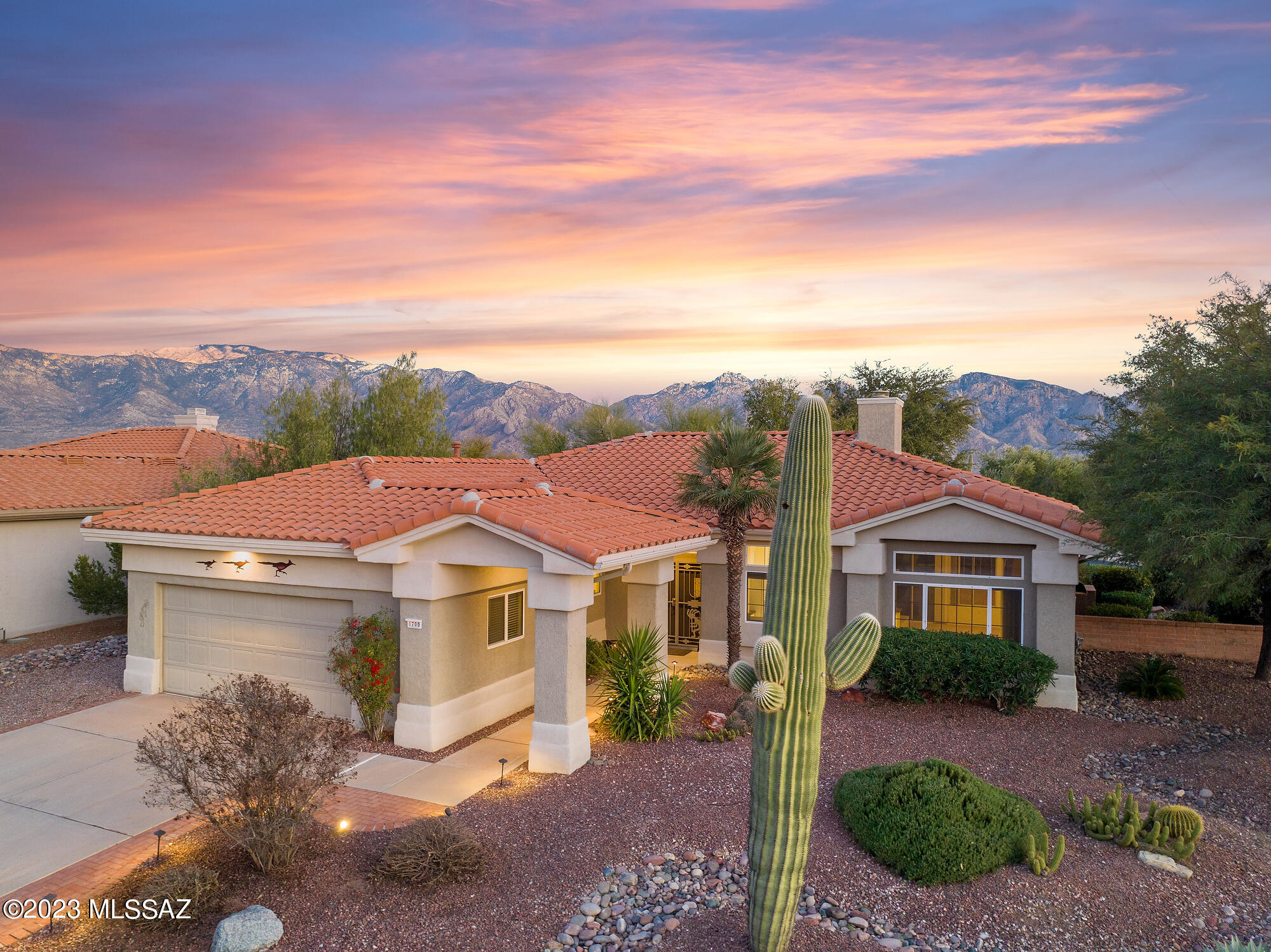 Come enjoy the resort style amenities of Sun City Oro Valley. This gracious home offers a sprawling open plan with two living spaces, gas fireplace, and high ceilings. Expansive windows bring in natural light to this neutral and beautifully maintained home. Bright spacious kitchen has island and desk area. Large primary suite offers generous sized bathroom and walk-in closet. Second bedroom, hall bathroom, and mud room complete this soft contemporary interior. Enjoy our stunning Arizona weather from the backyard with built-in bbq, covered porch, and citrus trees. Neighborhood features include pool, tennis, clubhouse, and adjacent golf course access/membership (for additional fee).