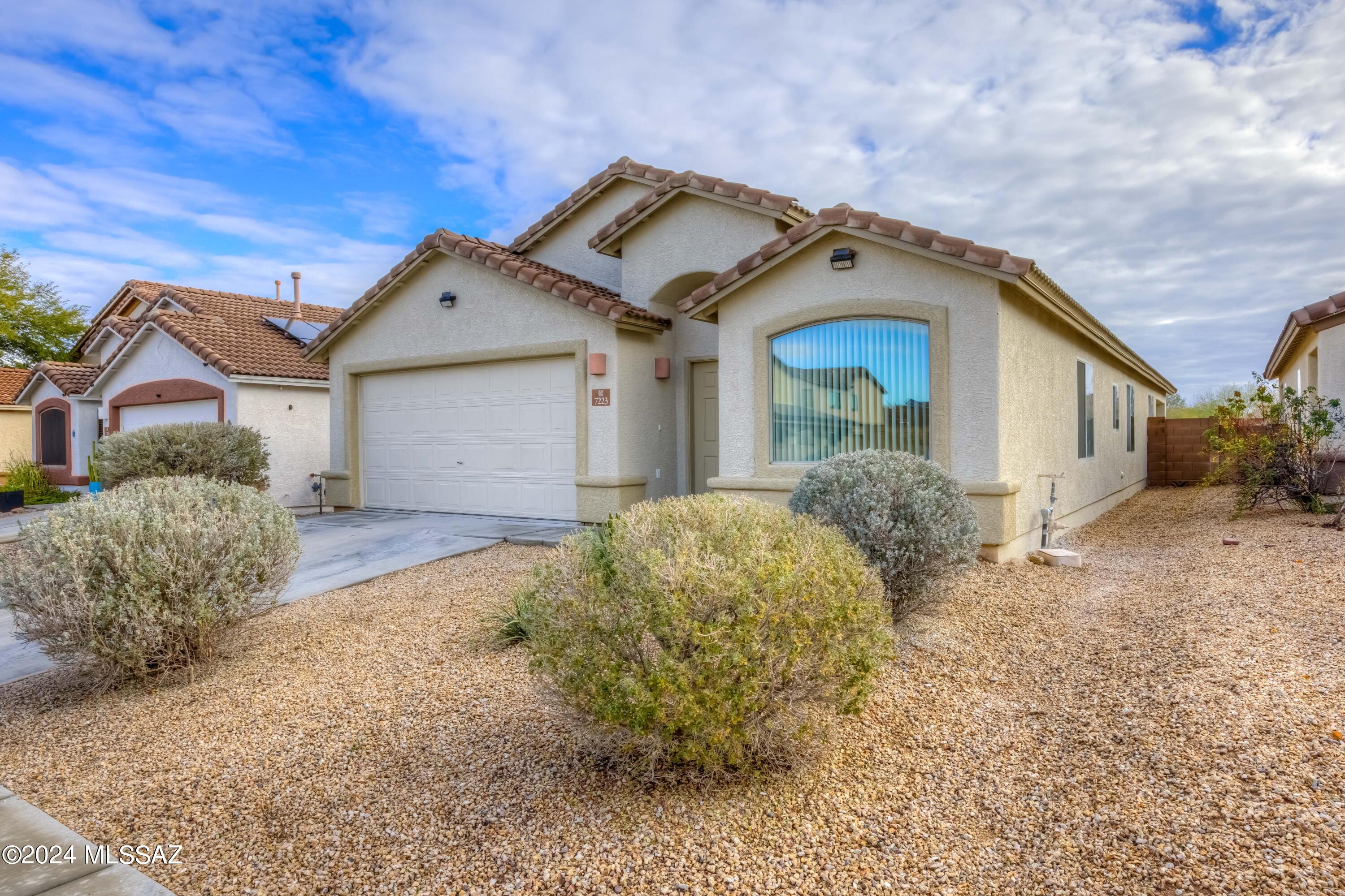Welcome to this stunning 4 bed, 2 bath Tucson home, where the beauty of desert living meets modern comfort. Step into a bright dining and living space with vaulted ceilings. Pass into the family room and kitchen featuring a convenient island, pantry, and plenty of cabinets for storage. The spacious primary suite offers a relaxing retreat with separate shower and tub as well as a walk-in closet. The three secondary bedrooms, give you ample options for a den, work -out area, crafting space or guest bedrooms! The backyard is wide open and ready for your personal touch to enjoy the stunning mountain views. Embrace the charm of desert living in this lovely move in ready home!