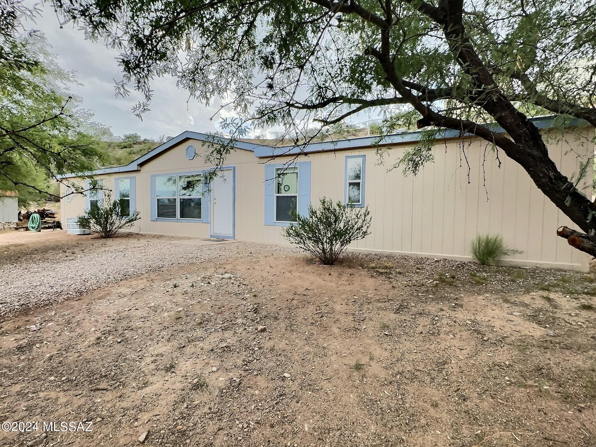 Roomy manufactured home on quiet cue-de-sac lot in Pomerene. Five bedrooms, three full bath and a great floor plan. Kitchen has plenty of storage and a breakfast nook with bright windows. Master bedroom opens to bathroom through French doors. Garden tub, separate shower and two separated vanities. Hallway leads to the additional four bedrooms and two bathrooms. Full Jack and Jill bath between two similar sized bedrooms. The other two bedrooms are on each side of the full hall bath. Storage shed and carport conveys with sale! Plenty of space for vehicles and kids to play. The hill behind the wood fence is included in parcel so imagine the possibilities! Plant trees and stairway gardens to extend your backyard living area.