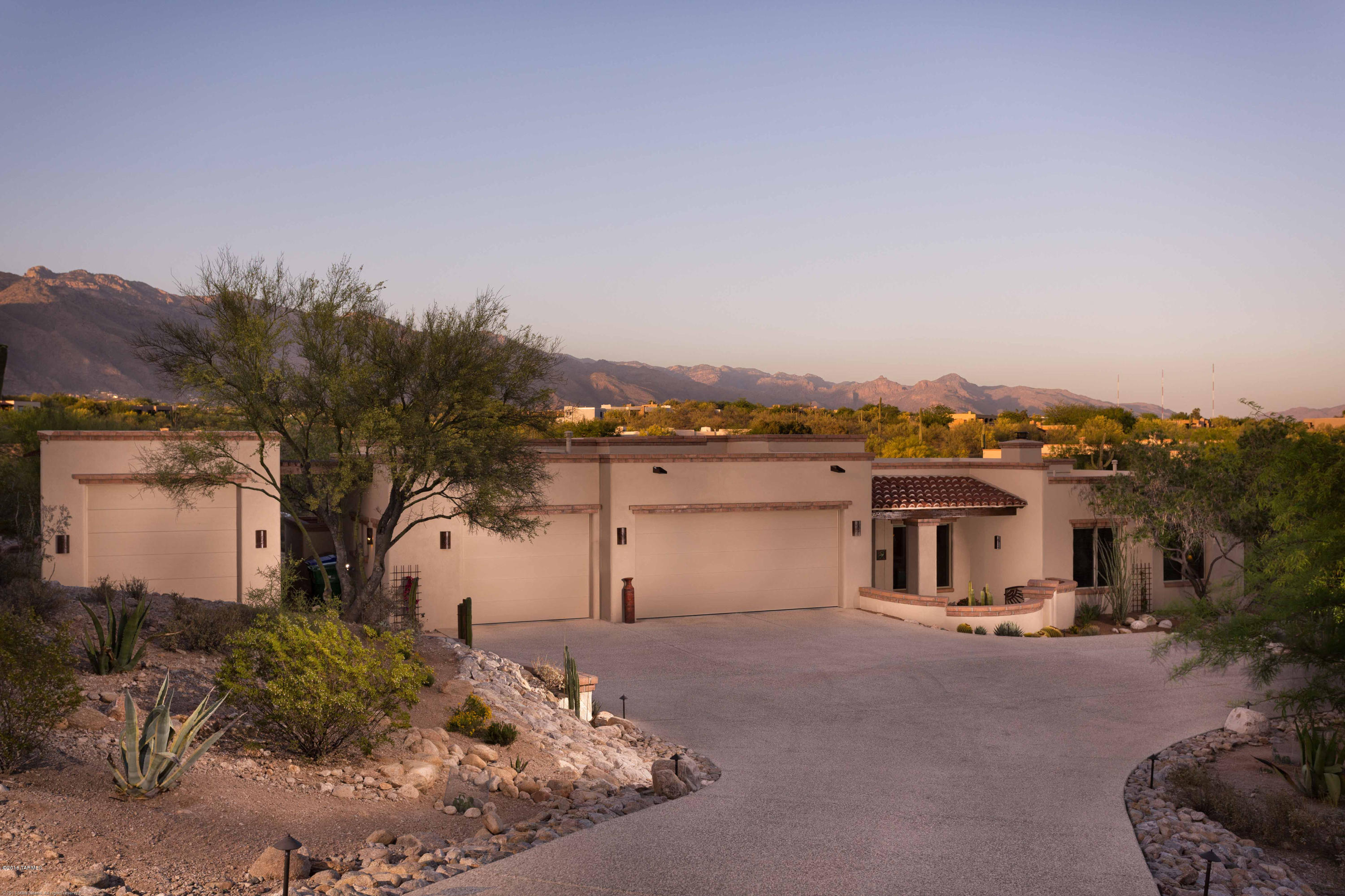 Custom-built John Kline masonry stucco home in guard gated Catalina Foothills Estates 10. Expansive mountain views on private lot. The entryway opens to a large living room framing views of the Catalina mountains with a wall of windows that slide out of the way for gracious indoor/outdoor entertaining. This three bedroom, 2.5 bath house features a split bedroom floorplan, maple cabinets, stainless steel appliances, granite countertops and skylights throughout. The private backyard is perfect for entertaining with pool, spa, fireplace, outdoor kitchen and brick patios. This home has a large three car garage plus a separate RV garage with windows and skylights.