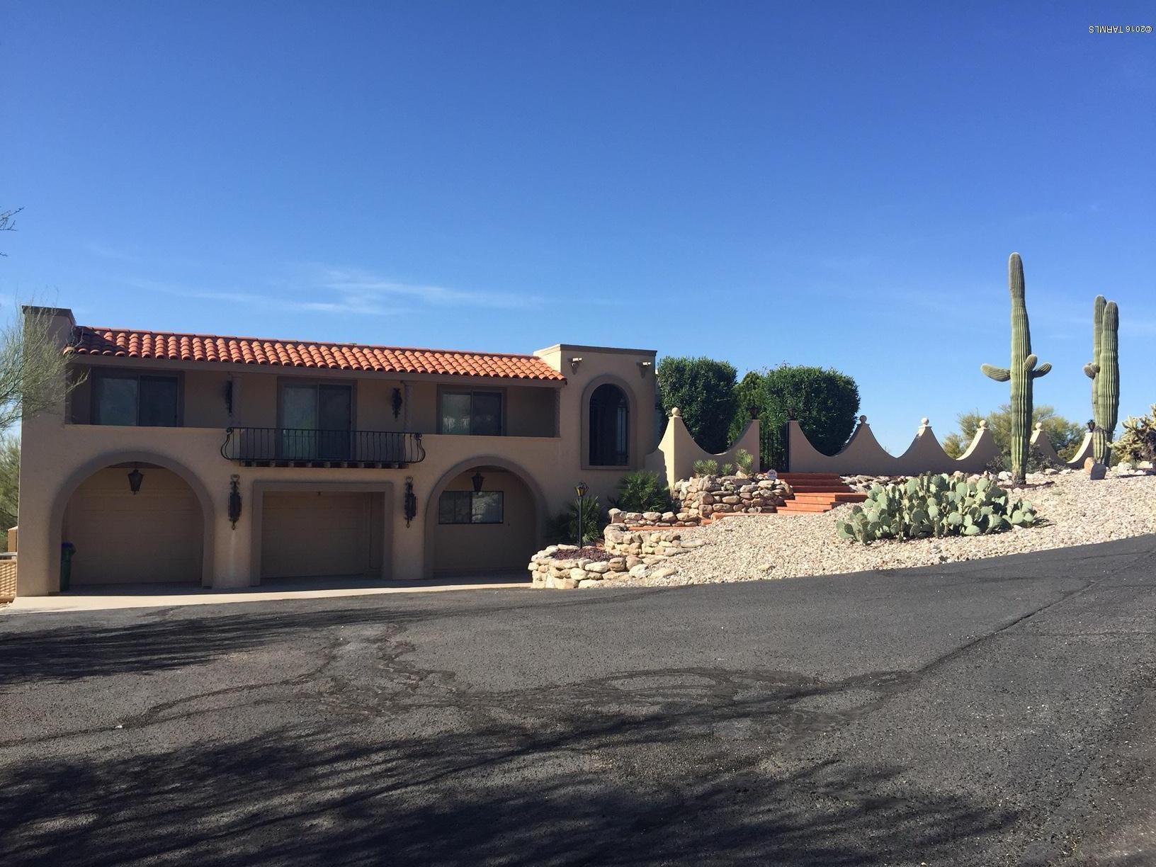 Wonderful hilltop home with stunning views. New kitchen cabinets and counter tops. New windows and doors. Large bonus room with fireplace, bar, 3/4 bath and direct access to very private Pebbletec pool area. Extra storage/workshop in garage. Beautiful grounds with mature landscaping and numerous saguaro cactus. Meticulously maintained and ready to move in.