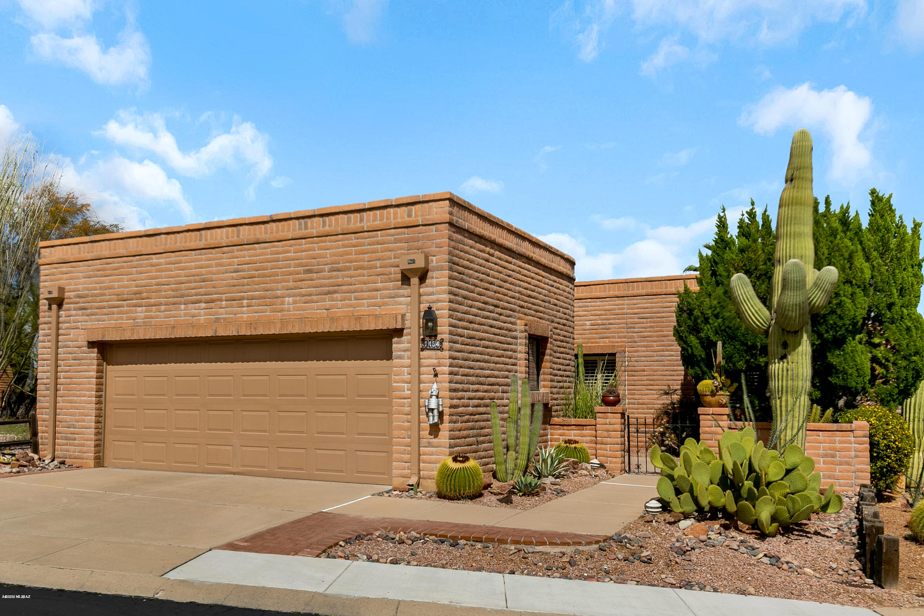 Mature, interesting landscaping will greet you as you enter this very comfortable and lovely home.  Tile throughout the home, The den can be used as a TV room, office or hobby room and offers extra space to use as you wish. Updated master shower.  Newer fridge and dishwasher in the roomy kitchen. This end unit offers additional windows to bring in extra light, one of which is over the kitchen sink. The plantation shutters throughout offer such a nice, tropical feel.  And wait until you step out on to the back patio.  The giant palm welcomes you to a serene, restful area with mountain views as well as views of the new Pima County Park with miles of walking trails and lush open areas to enjoy. Oversized garage, newer water heater with instant hot surge added. Come enjoy Green Valley!