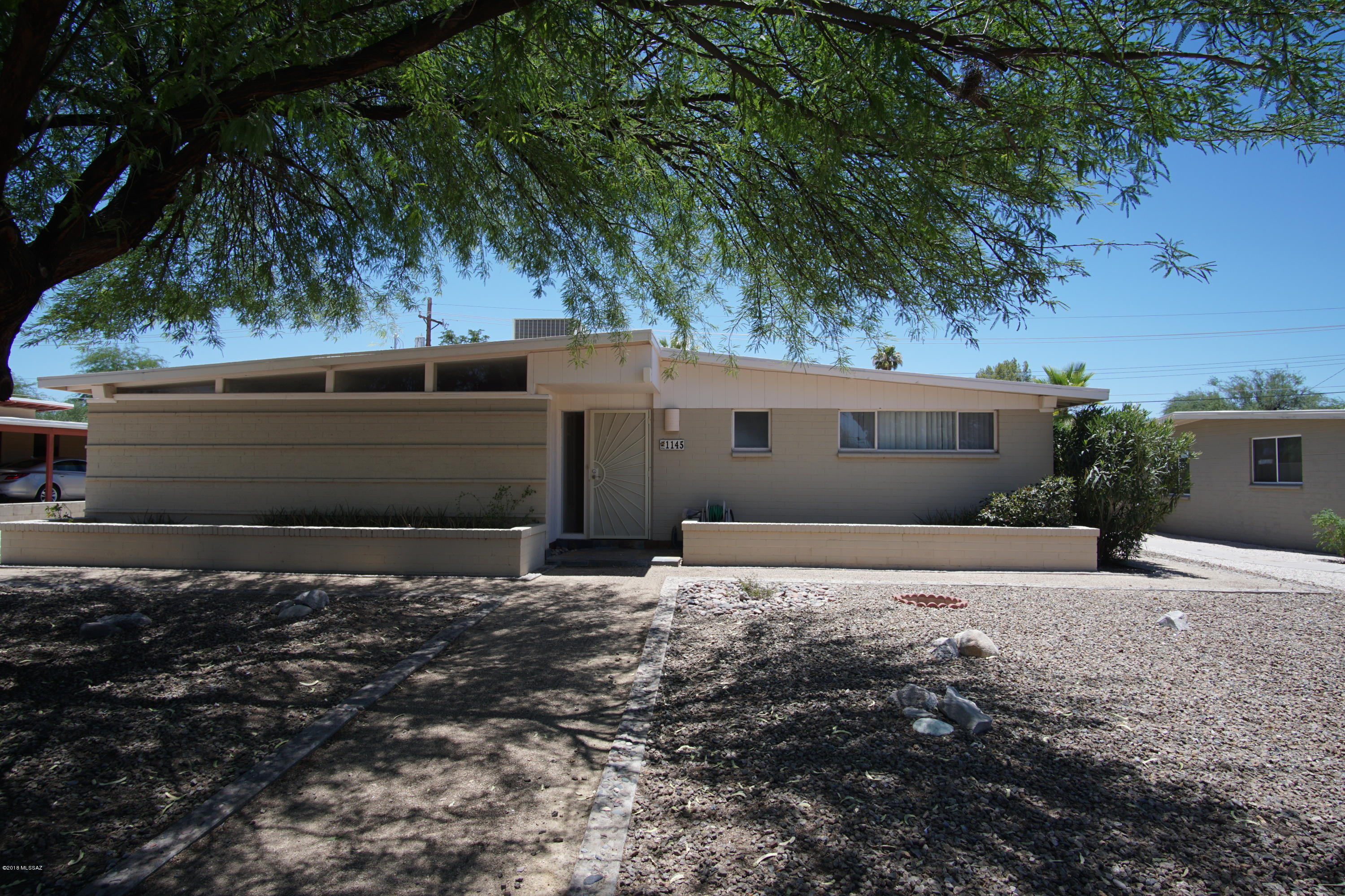 If you are looking for convenience - look no further.  Located in the North/Northwest area of Tucson with nearby shopping, restaurants, and public transportation.  This ranch style family home welcomes you into a generous living room that overlooks a sparkling conventional pool.  The kitchen has granite tile counters, stainless steel appliances, and a spacious area for casual dining.  The master bedroom offers a secluded escape from the other bedrooms.  New carpet - new paint - new window coverings too!  Large walled backyard, covered carport and storage room.