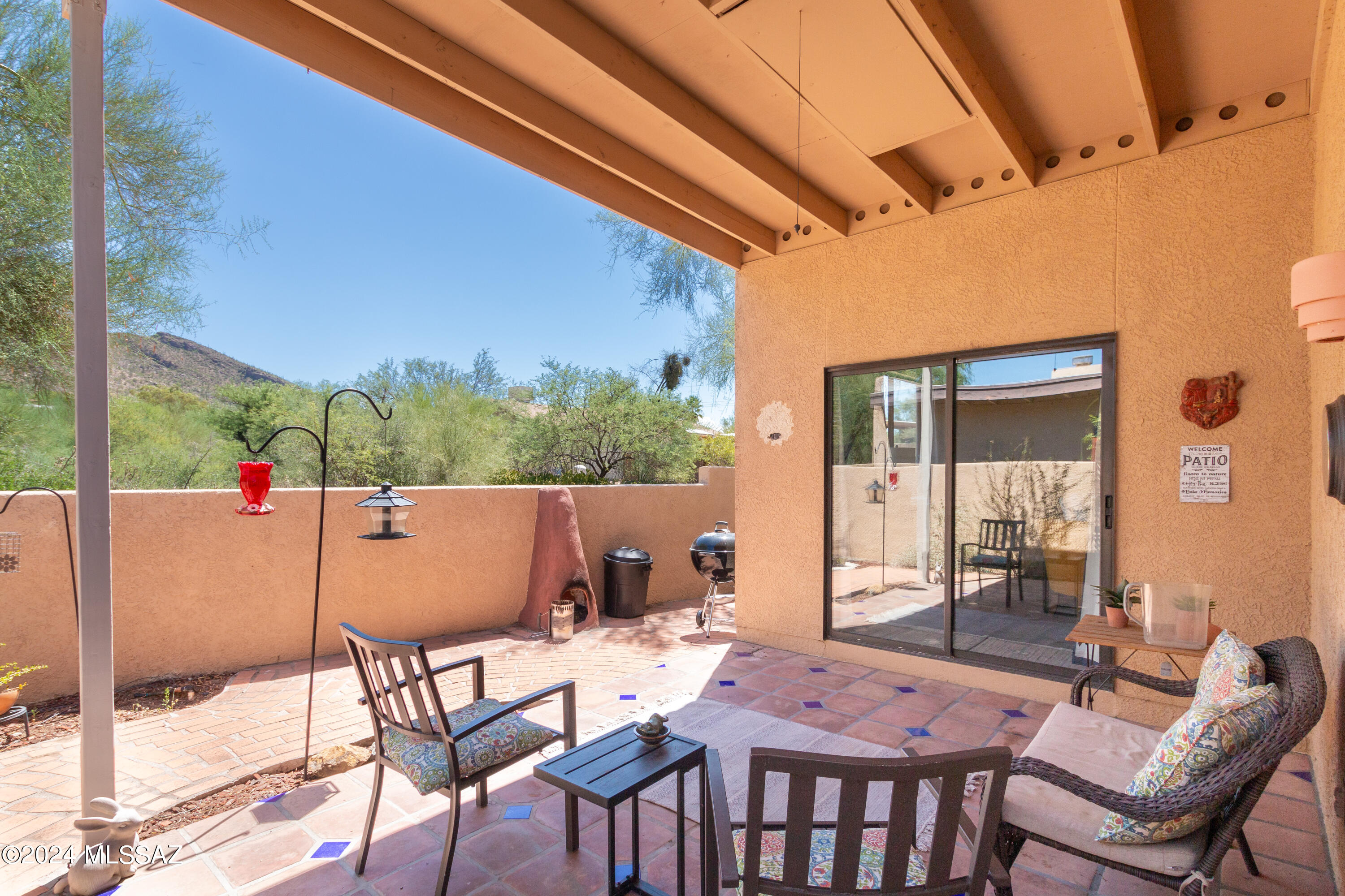 Investors dream or perfect move-in ready home. Welcome to this beautifully updated townhome in the desirable town of Oro Valley with stunning natural surroundings. Boasting the largest floor plan in the community, this spacious 3-bedroom, 2-bath end unit is perfectly positioned on a corner, offering unmatched privacy and breathtaking mountain views. Open living room with a cozy fireplace, low-maintenance wood-look laminate flooring throughout (no carpet) and multiple skylights that provide plenty of natural light. Kitchen has granite countertops, ample cabinet space, and sleek black and stainless appliances. Primary bedroom offers a spacious layout, walk-in closet, two separate vanities, tiled shower and access to the back yard through a glass sliding door. Private 2-car covered parking space with a large storage closet, new water heater in 2021 and roof recently maintained and fully re-coated. Plus, the fridge, washer, and dryer can convey. Conveniently located near hiking, shopping, dining, golfing and many town amenities. This property is currently operating as a successful short-term rental, generating an average monthly income of over $3,000. The home is fully stocked, with all furnishings and rental essentialssuch as dishes, utensils, small appliances, towels, bedding, bikes, and a BBQavailable for purchase through a separate bill of sale. With bookings already secured through the end of 2025, this is a truly turn-key investment opportunity. The new owner can choose to either request renters to transfer current bookings or owner will cancel if they prefer not to continue using the property as a short-term rental.