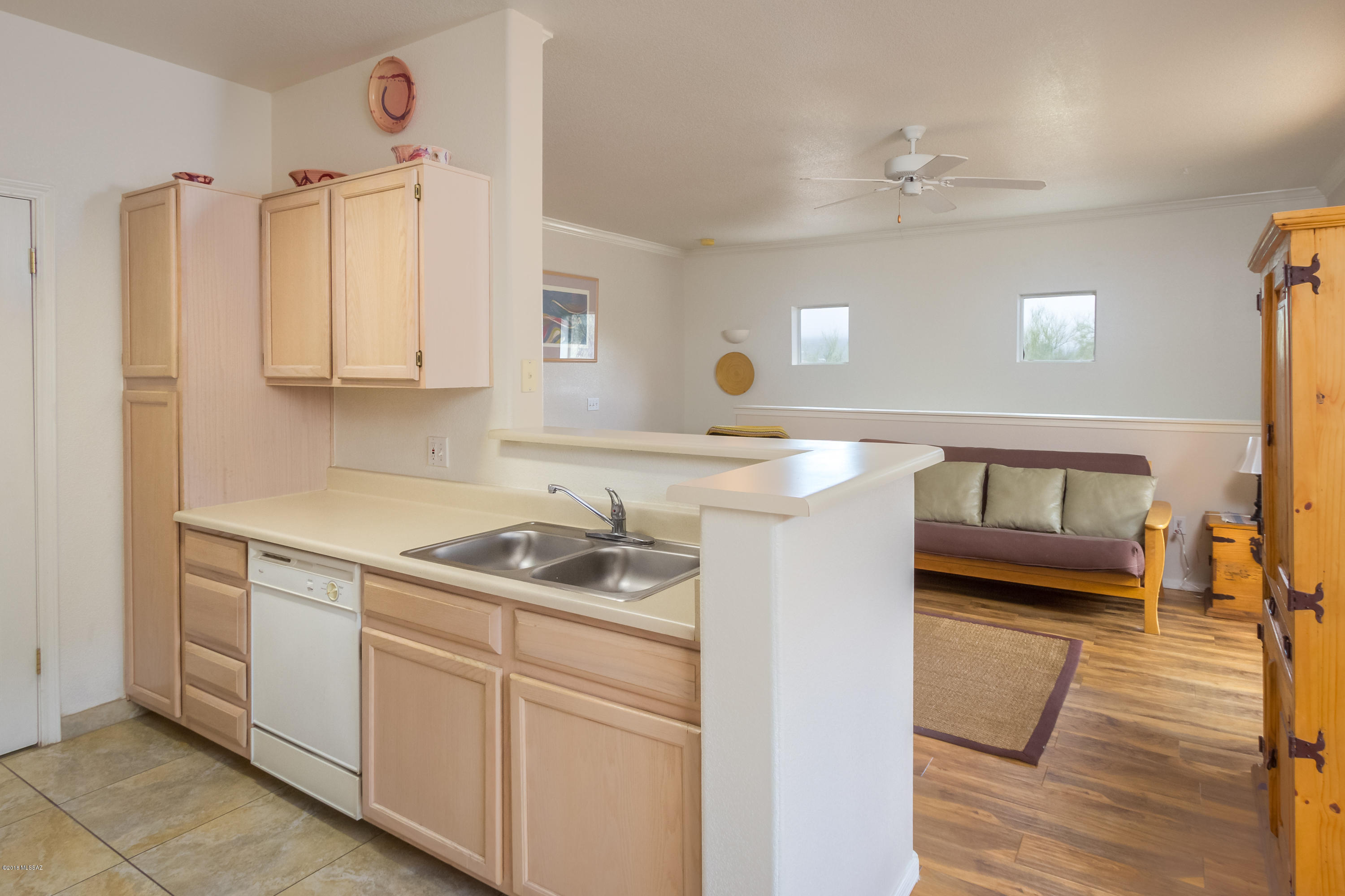 Location, location here with this beautiful upstairs 1 bedroom unit and breathtaking views of the Catalina Mountain Range!  Have your breakfast on your covered patio and watch the sun come up over the mountains and look at the wooded mountain directly to the south and maybe catch some wildlife!  Very private unit as common area to the east of your home and view wildlife from your kitchen/dining window as well. Just a perfect location within the community to have it all! Enter to carpeted steps and the rest of the unit has hard flooring.  Newer beautiful commercial grade wood laminate in the great room, bedroom and remaining areas have a large light-colored tile easy to decorate with.  Tons of storage throughout the unit! Grocery, fine dining and Sabino Canyon close by! The resort style complex amenities include a heated pool, spa, exercise facilities, clubhouse, bbq area and park like grounds.