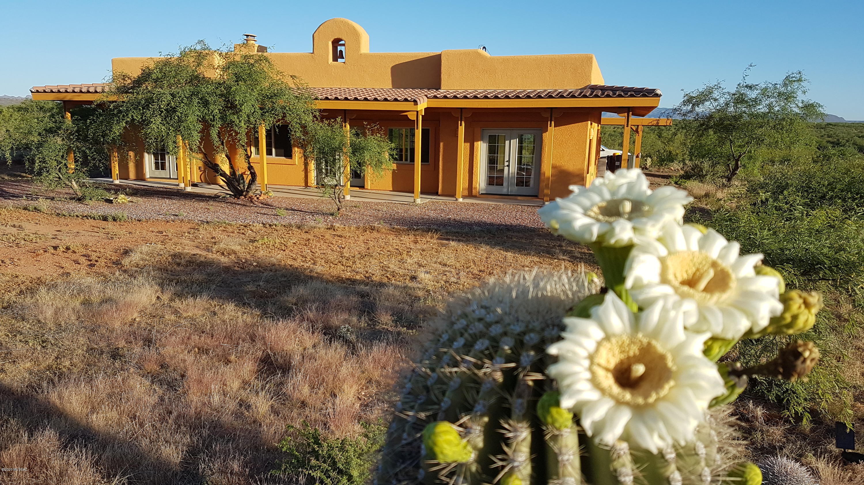 Super mountain views,  privacy, gated entry and acreage will be the first impressions you see upon your arrival at this unique one-of-a-kind property.  10 Acres (subdividable), private registered well, and panoramic views.  Plentiful saguaros abound in this unbelievable setting.  Enjoy the sunrise/sunset from the wrap-around porch.  Built by Pierce Homes, with 2x8 exterior walls, additional insulation, two master suites, and a split floorplan. The cozy living/dining area is between the two suites.  The bathrooms have wall-hung toilets and vanities.  RV parking available.  Easy access to Green Valley and all it has to enjoy. This property is a jewel and a must-see.  Hardly lived in.  Owners visit from Switzerland only several months a year.
All of the furnishings available by SBOS.