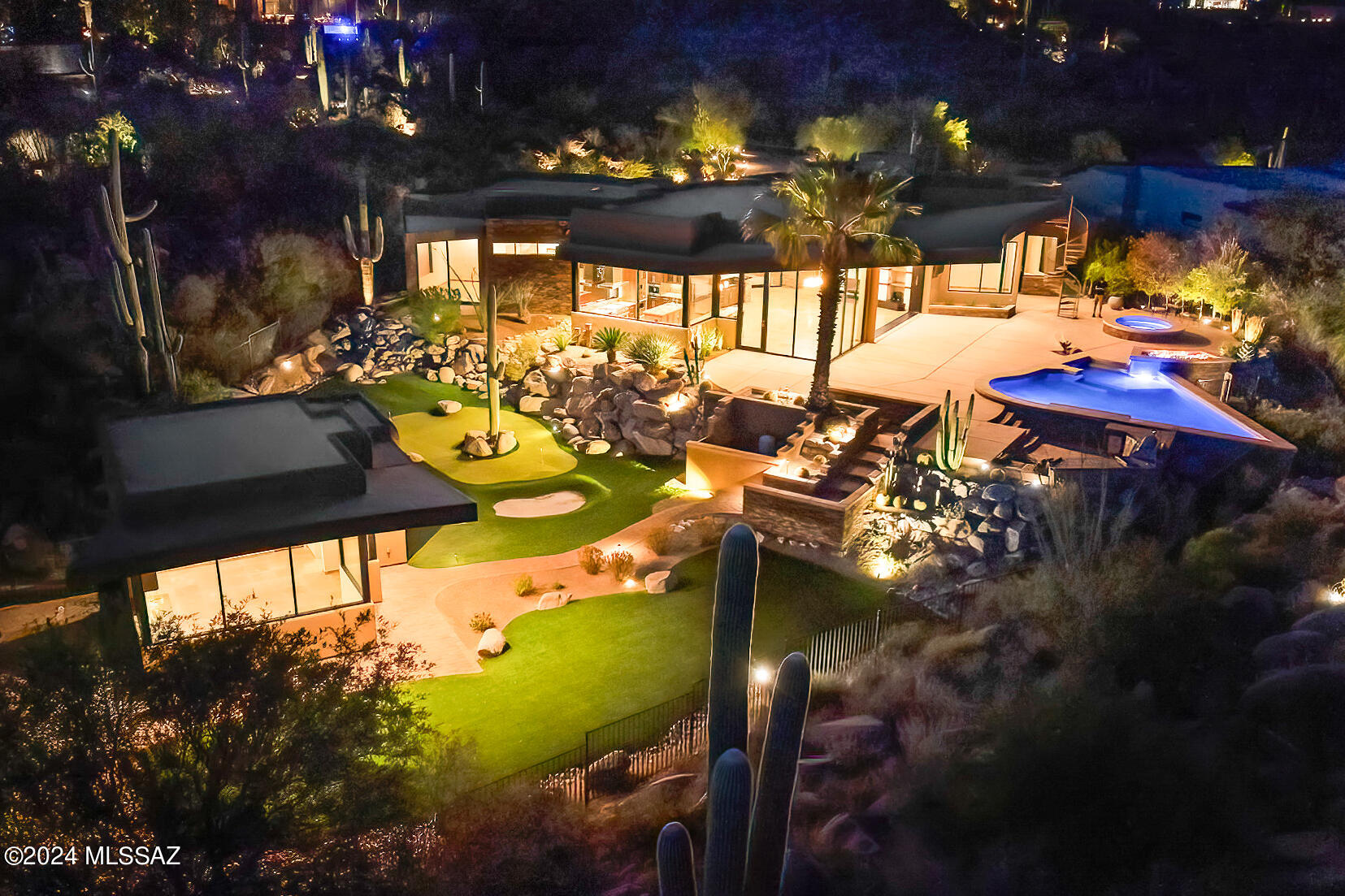 Embrace unparalleled luxury in Stone Canyon's guard-gated golf community with this contemporary masterpiece! Set on 1.77 acres with captivating Catalina & city light views, this exceptional estate by acclaimed architect Marc Soloway features 5BR, 5BA, sunlit kitchen, Viking & Sub-Zero appls, wetbar and office/den/media room in 3,868 SF & 453 SF Guest House. The Great Room's massive window wall disappears to merge the inside with an outdoor paradise! Lavish covered patio, roof deck and array of luxurious amenities (spa, firepit/water feature, pool, swim-up bar, BBQ kitchen, putting green) set against a dramatic backdrop of natural rock formations with cascading waterfall create a haven of privacy & tranquility. This magnificent Stone Canyon oasis offers a lifestyle of unparalleled luxury!
