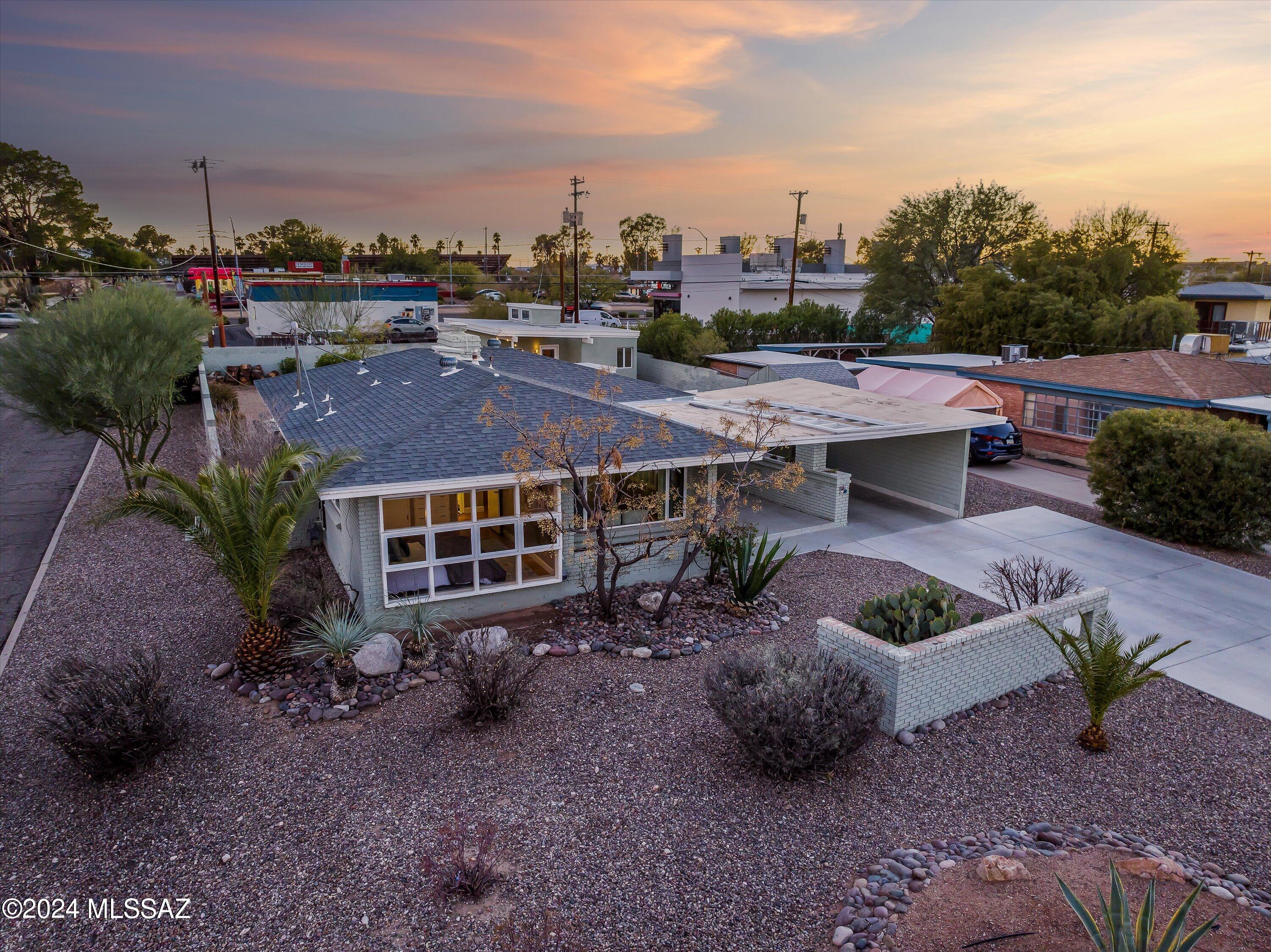 Welcome to your new home! Historic property situated on a large corner lot, this beautiful 2-bedroom residence plus guest house epitomizes comfort and style. A carport parking, desert front yard, & a front porch are just the beginning. Discover an inviting living room adorned with a fireplace and floor-to-ceiling windows offering an unobstructed backyard view. The kitchen features SS appliances, quartz countertop, white cabinetry, a breakfast bar, and a cozy nook. Let's not forget the backyard! Beautifully landscaped, putting green, and room for relaxation & entertainment. Want more? The separate guest house will surely impress you! Its living area, sleeping quarters, bathroom, and well-equipped kitchen make it a truly luxurious addition to the property.
