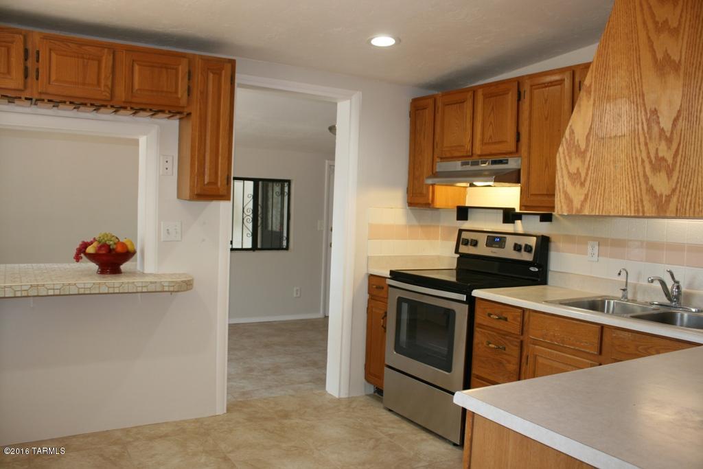 Rare find! A 4 bedroom 3 full bath home in Central Tucson on a .19 ac lot. Shady parking, large laundry room, block wall, carport, AC, citrus trees, security bars. Work recently completed: Rheem AC/heater, 90% of duct work replaced, carpet & tile, interior paint, canned lighting in most rooms, barn door installed in master bedroom, Toilets, 2 sinks and faucets replaced, stainless steel oven/stove/hood & dishwasher, LED remote fan/light in master, fresh baseboard in dining rm, living room, master. All lighting is LED- (all 16 canned lights use less energy than 2-100W incandescent bulbs!). Fresh and move-in ready!