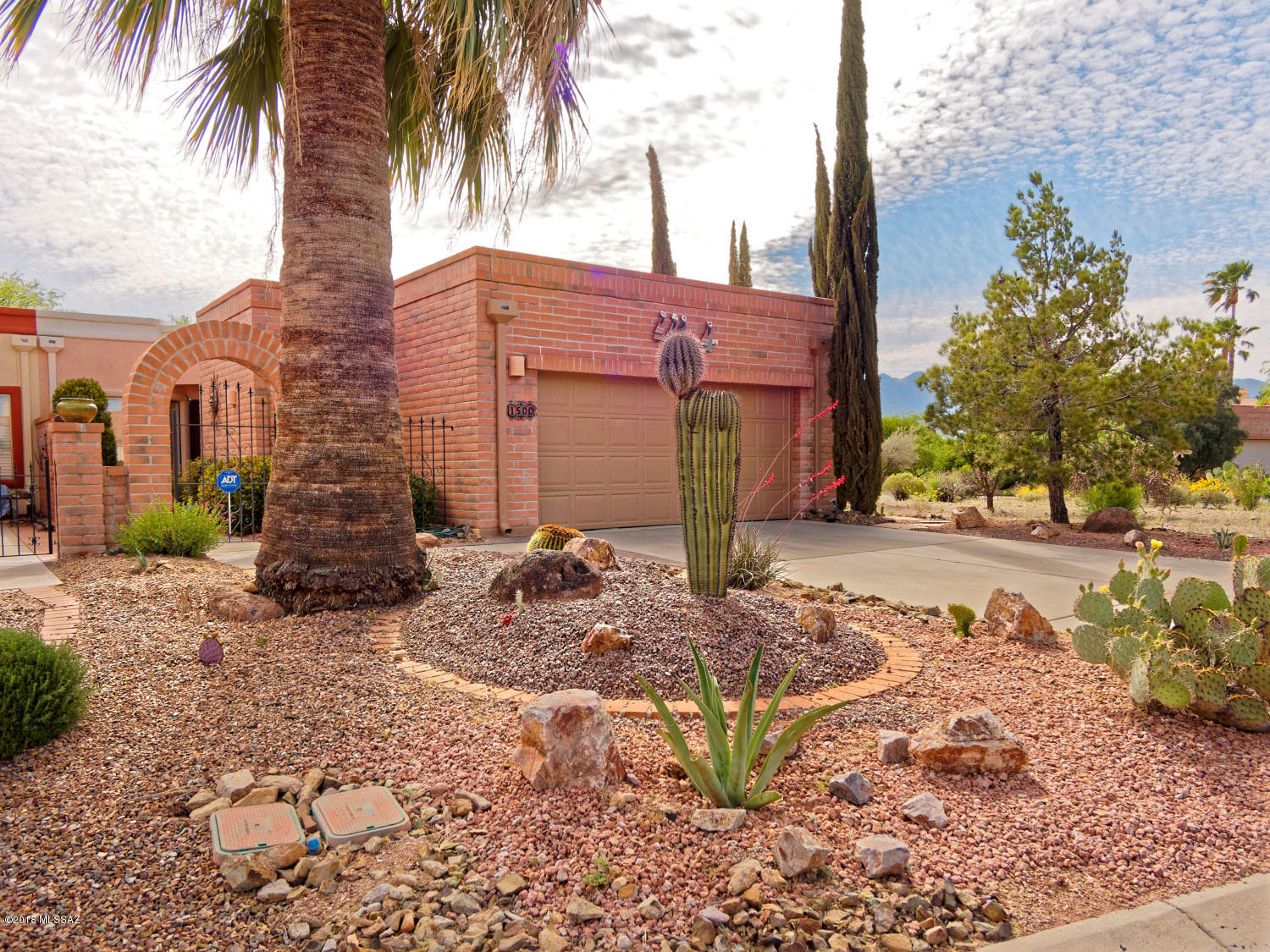 Well cared for end unit townhome with nice mountain views. Large 2 car garage, plenty of storage and area for laundry and pebble tec style flooring. Large eat in kitchen, dining area, living room with two way fireplace. Master bedroom has a sitting area on other side of two way gas log fireplace. Very cozy and nice mountain views. Split bedroom floor plan. Nice brick entryway, new security door, the rear patio has water feature and great mountain views and a lovely spot to enjoy your evening wine or morning coffee. A lovely and clean unit.  New tile flooring, carpet in bedrooms and a security system which you can activate. Soft and bold  southwest colors throughout this town home. Just a little gem.