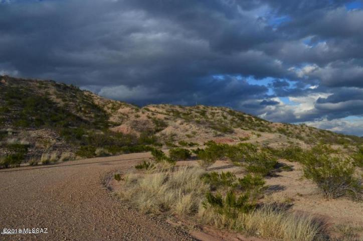 Lots of improvements and privacy.  Water with meter already in. Nestled in between some 100 foot hills it backs up against a nice wind break.  The views out the front of the Tanque Verde Mountains are first class. 2 miles from I-10! No HOA, upscale homes on road. No manufactured homes is the only restriction.  No minimum size on home.