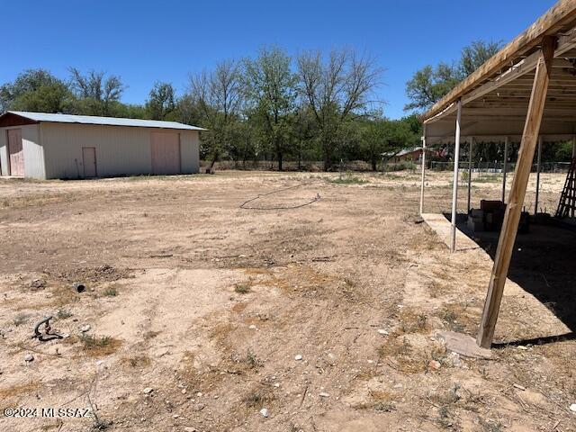 Property has a large barn, septic tank, and electric on the lot. Water is available from Saint David Water Company on Merrill Dr. There are 4 mature pecan trees on the property. Property is tucked behind another residential lot for privacy. Very nice level buildable lot.