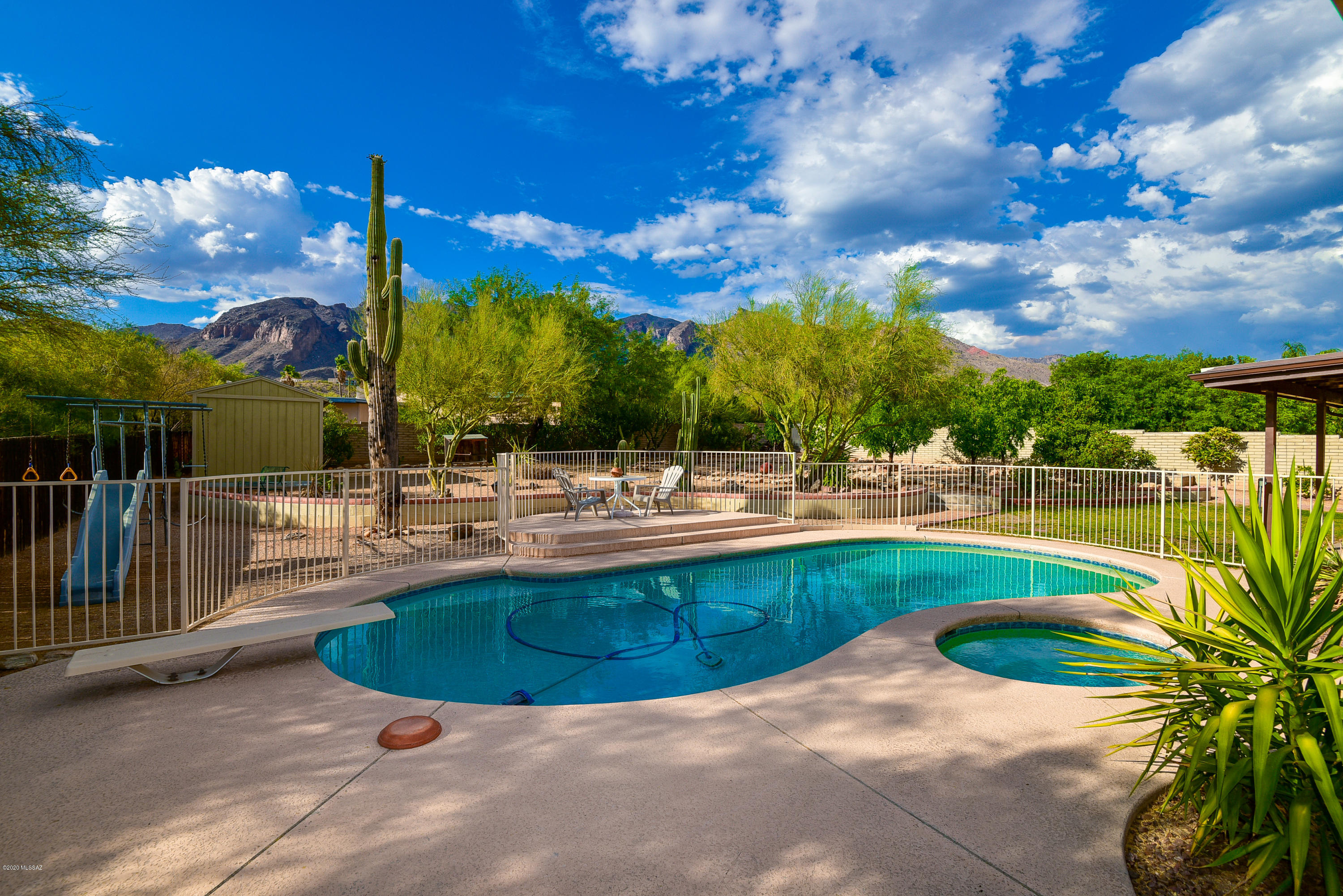 Enjoy stunning mountain views from this 4 bed/2 bath cul-de-sac home in the heart of the Foothills Clusters. The backyard is the oasis you have been looking for; complete with a pool, spa and lush desert landscaping. Inside this classic slump block home you will find a spacious great room and separate family room with a wood burning fireplace. With 2010 sq ft, there is plenty of space to create your signature style. Plus, this location is ideal with an easy commute to Catalina Foothills schools, shopping, dining, and beautiful hiking trails. Come visit today and fall in love!