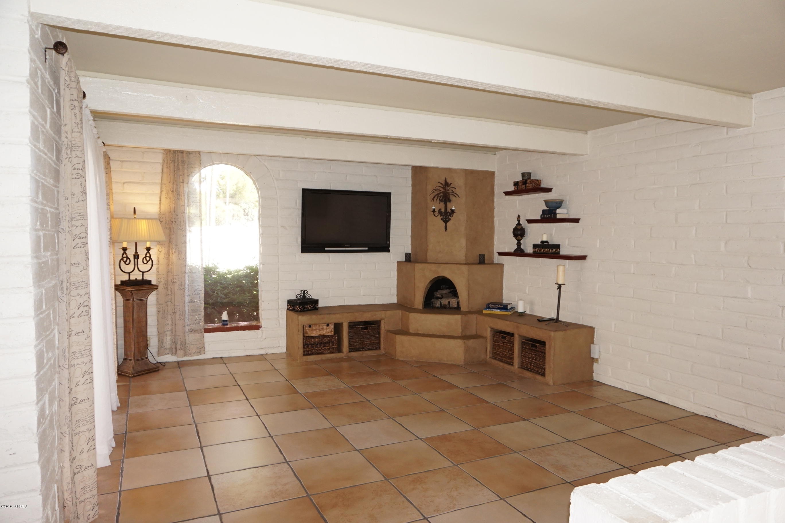 LOVELY 2 BR/ 2 BA BURNT ADOBE HOME IN  CASITAS DE CASTILIAN, A VERY SPECIAL OVER 55 COMMUNITY ON 17 GREEN ACRES OF COMMON AREA IN CONVENIENT ORACLE/ ROLLER COASTER AREA. UPGRADES INCLUDE COZY GAS FIREPLACE, BEAMED CEILINGS, FRENCH DOORS LEADING TO PATIOS, CERAMIC TILE FLOORING THROUGHOUT HOME (NO CARPET), GORGEOUS UPDATED KITCHEN WITH GRANITE COUNTERS, MAPLE CABINETS AND STAINLESS STEEL APPLIANCES, MANY SKYLIGHTS AND CEILING FANS, FAUX PAINT, FRONT AND BACK BRICK PATIOS, CUSTOM BUILT-IN BBQ AND A GREAT LOCATION CLOSE TO HEATED COMMUNITY POOL AND CLUBHOUSE. HOA FEE COVERS WATER, GARBAGE PICK-UP, SEWER, INSURANCE, 2 HEATED POOLS, TENNIS, PAINTING AND MAINTENANCE OF THE BUILDINGS. ONE DOG ALLOWED PER UNIT, 2 PETS TOTAL.