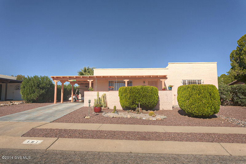 Price Reduction...Ideal Winter Residence or Year Round Home. Investors, your opportunity for ''ready to rent'' property. The views of the Santa Rita Mts. can be enjoyed from this enclosed front patio. Tile throughout except for the bedrooms. The open living room/ dining area leads onto a tiled covered patio. A wood workers or artist dream space is available just off the patio ..a large spacious private studio. Relax in your backyard with the sounds of the water feature, the beauty of the citrus tree; you can even walk ''barefoot in the grass''. This house is just waiting for you to turn it into your home!