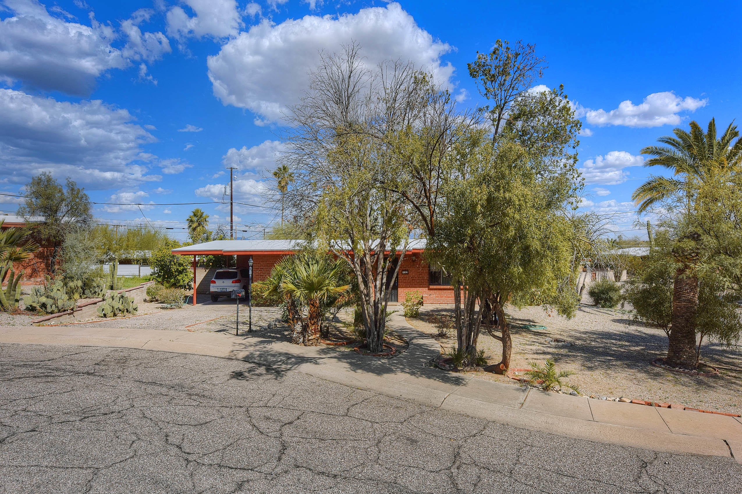 Charming west side Ranch home in a highly desirable neighborhood with 2 bedrooms, 2 bathroom and phenomenal extra room that can be used as storage, office, workout, and/or playroom. Only 3.5 miles to University of Arizona, 2.5 miles to Downtown, this property has a wonderful location with easy access to I10, shopping, restaurants and offices. Great value with nice sized bedrooms, walk-in closet, ceiling fans, comfortable living area and great outside space. Great floor plan with all tile throughout and nice sized bedrooms. Main bathroom has shower/tub combo and an additional bathroom off the bonus room. If you are seeking a well built home with great curb appeal and fantastic location, don't look any further. Located in a cul-de-sac with large corner lot and nice palm trees.