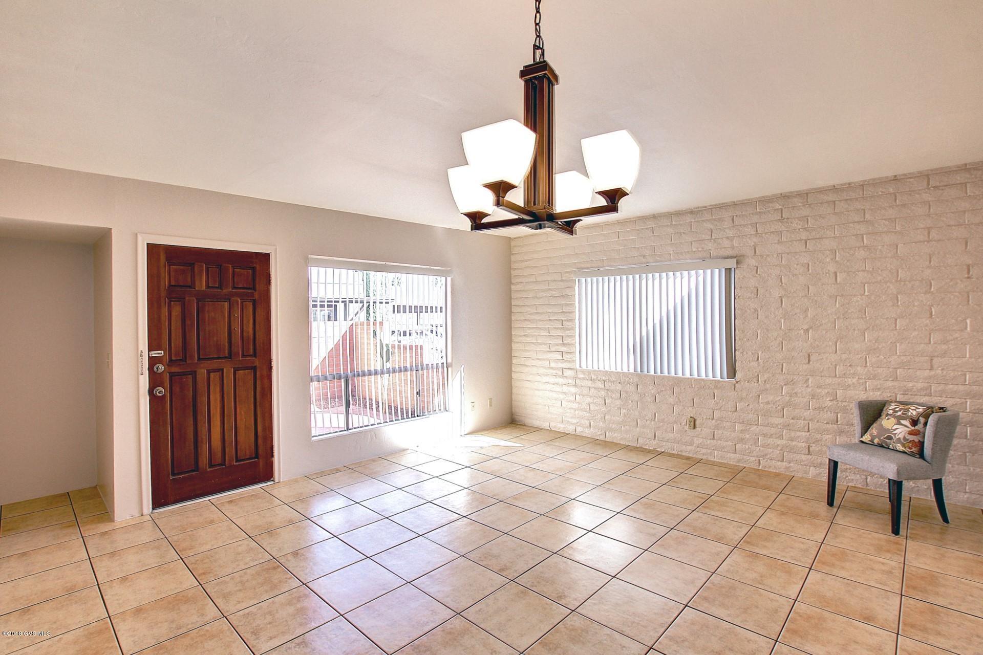 Green Valley Charmer! This 918 sqft light and bright townhome, in Casa Paloma 1, offers an Open floor plan with Tile flooring throughout. With 2bd/2ba + 1 car carport is the perfect Winter Retreat. Fresh neutral interior paint, New front and back security doors, New light fixtures, New window treatments. Front Patio offers partial MTN Views while the Good size Back Yard opens to the Desert Common Area with No Neighbors Directly Behind. Master bedroom with plenty of closet space. Stackable washer and dryer in interior closet. Enjoy the community pool. Great location close to shopping, library, restaurants, easy access to I-19. Age Restricted. GVR membership.