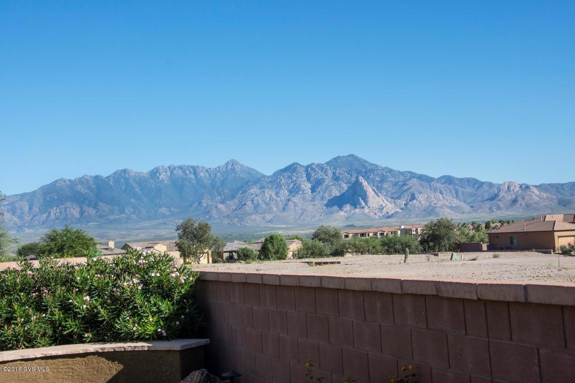 Are you looking for a well-loved beautiful home in the Canoa Ranch area that sits up high with fabulous mountain view? This home is it! The back yard is great for entertaining with a built in barbeque with 2 extra burners and a sit up bar. The stone cactus fountain provides the sound of a tranquil back yard paradise. As you walk inside you will see the classy granite kitchen with tile back splash and stainless steel appliances. The den, master bedroom and garage have the custom California closet designs and the den has a murphy bed and built in desk area. This well maintained gorgeous home has high quality designs inside and out. Call for an appointment today!